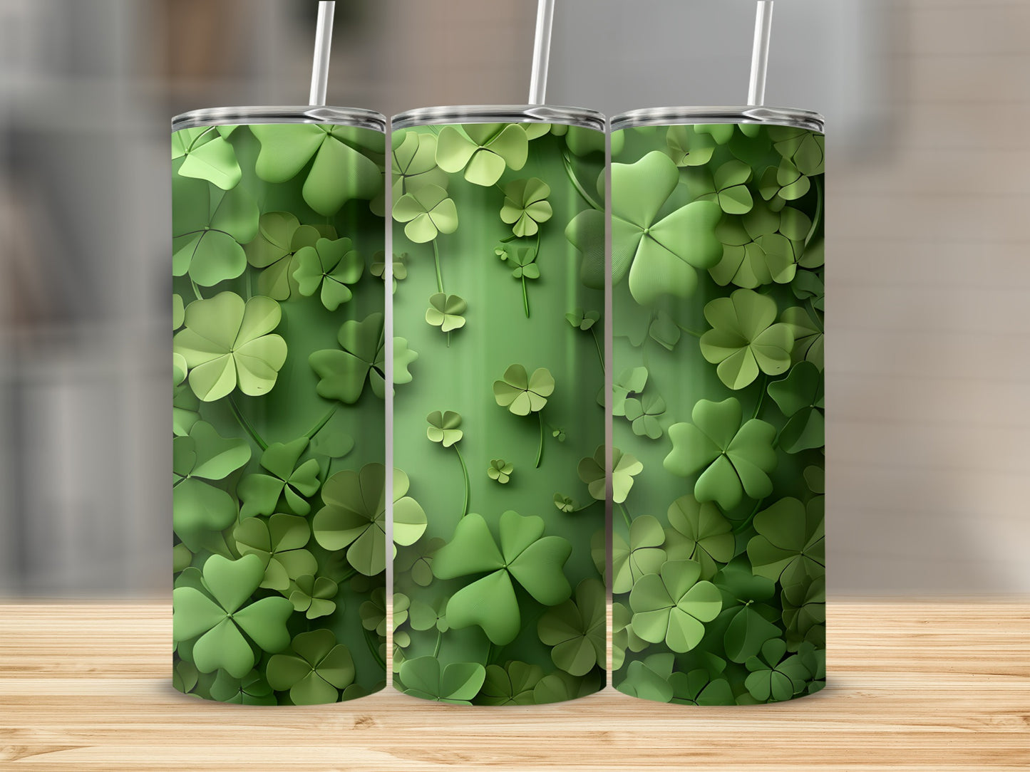 Three green tumblers with shamrock clover patterns on a wooden surface.