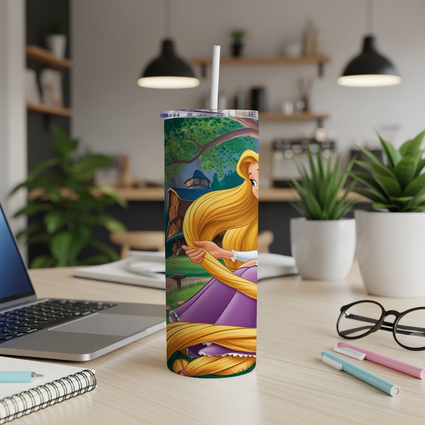 Rapunzel on a tumbler with a straw, on a desk with a laptop and pens.