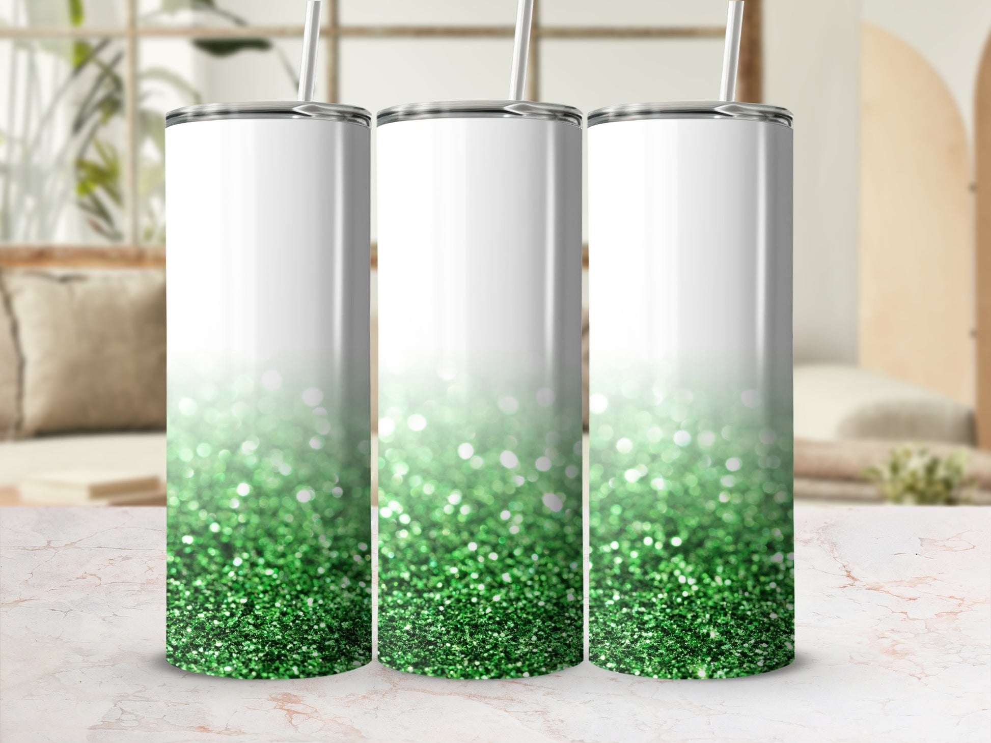 Three tall white tumblers with green glitter ombre effect.