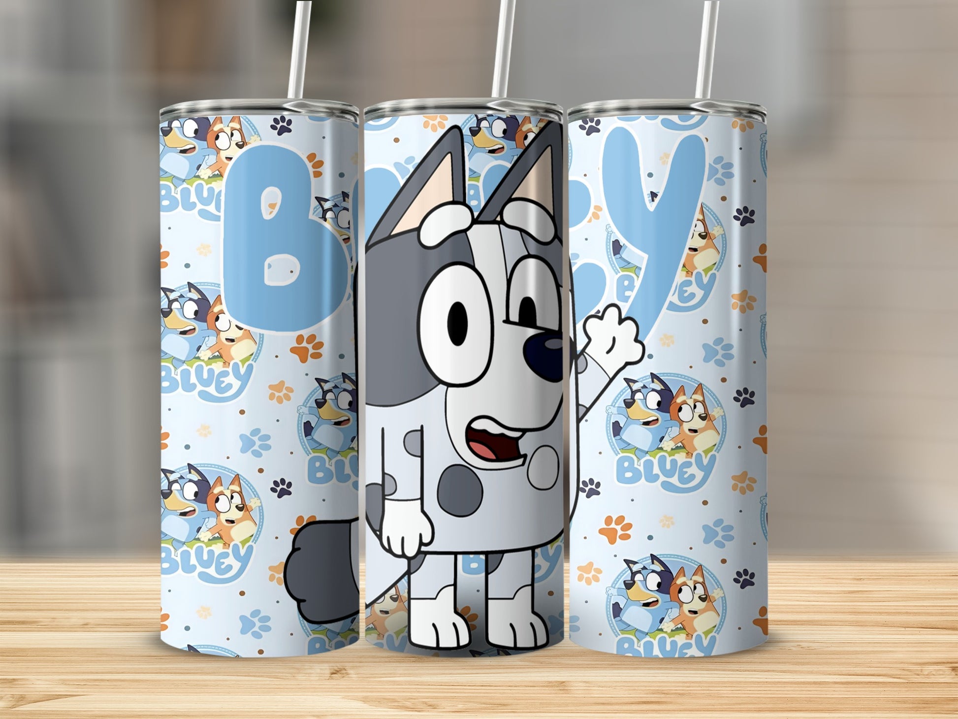 Bluey character tumbler with cartoon Bluey, Bingo, andpaw prints.