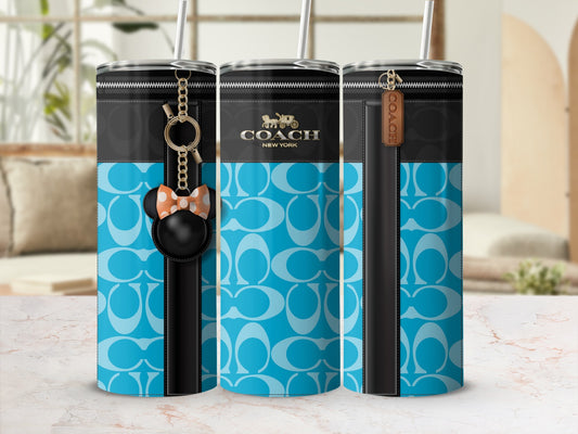 Coach tumbler with signature logo pattern and character charm.