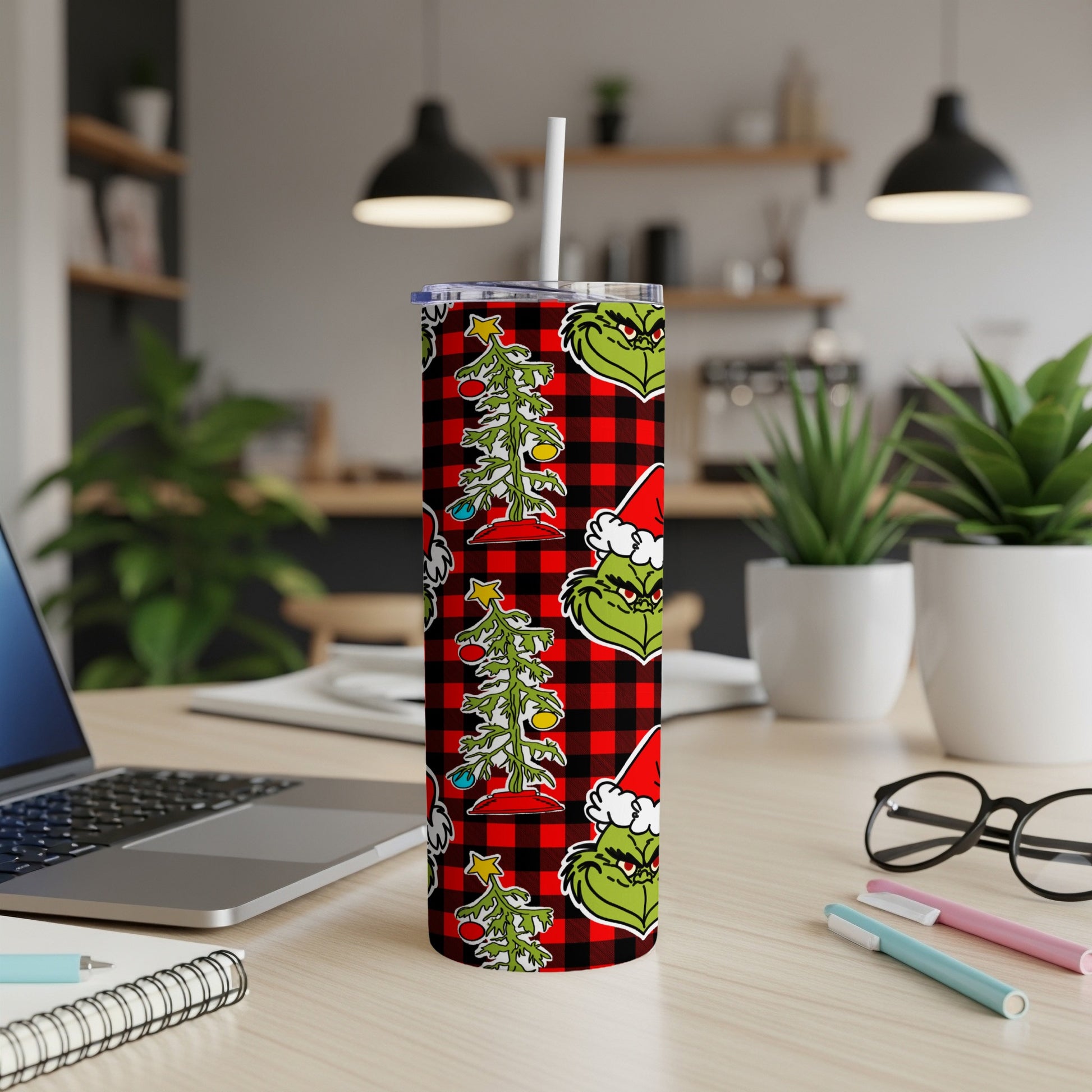 Grinch Christmas tree pattern tumbler with red buffalo plaid background.