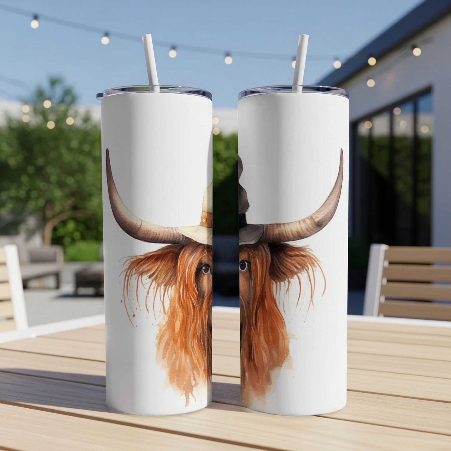 Two tumblers with a watercolor Highland cow wearing a witch hat.