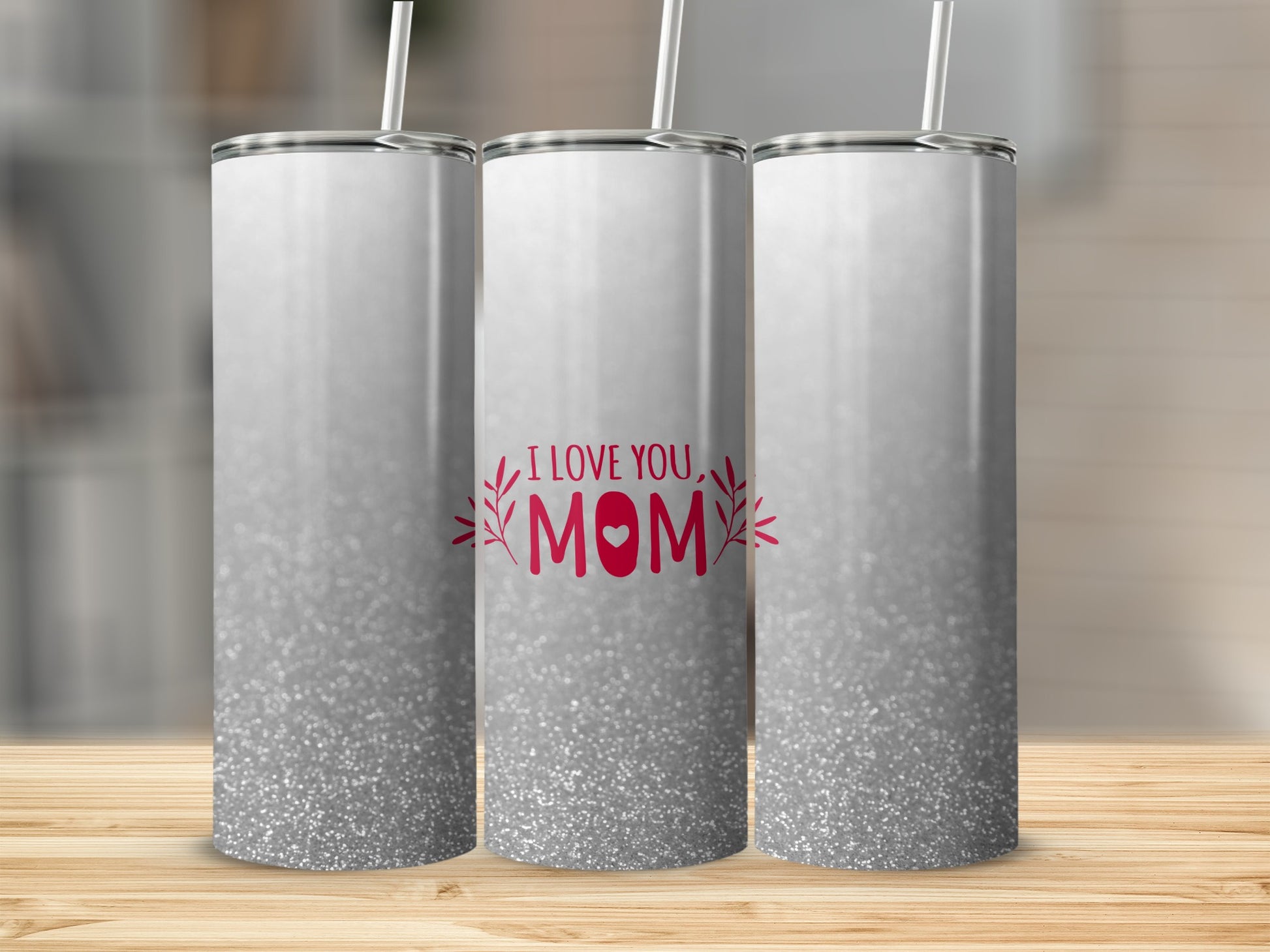 White tumbler with "I LOVE YOU MOM" and floral design on gradient background.