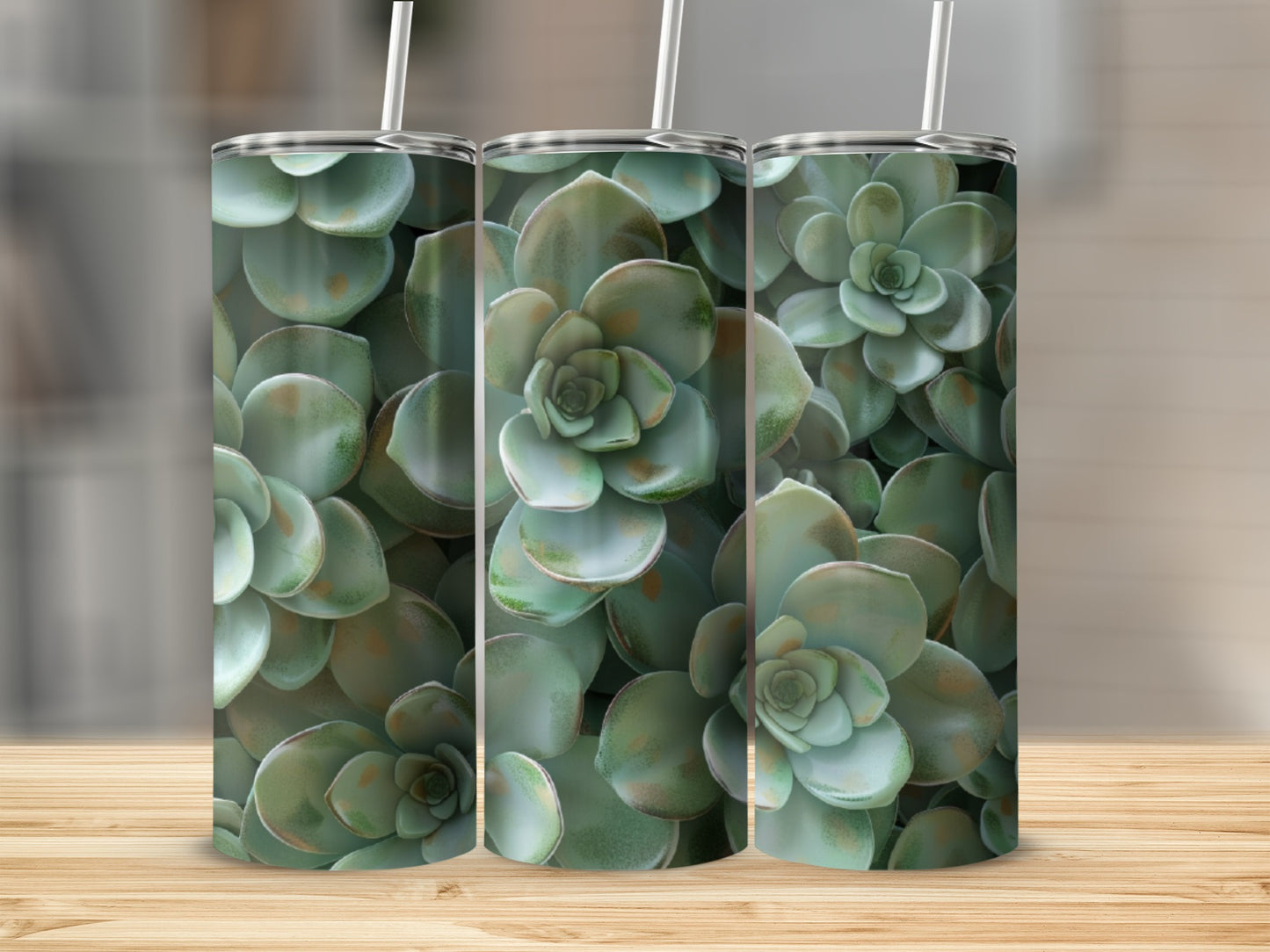 Three tumblers with a succulent plant pattern on a wooden surface.