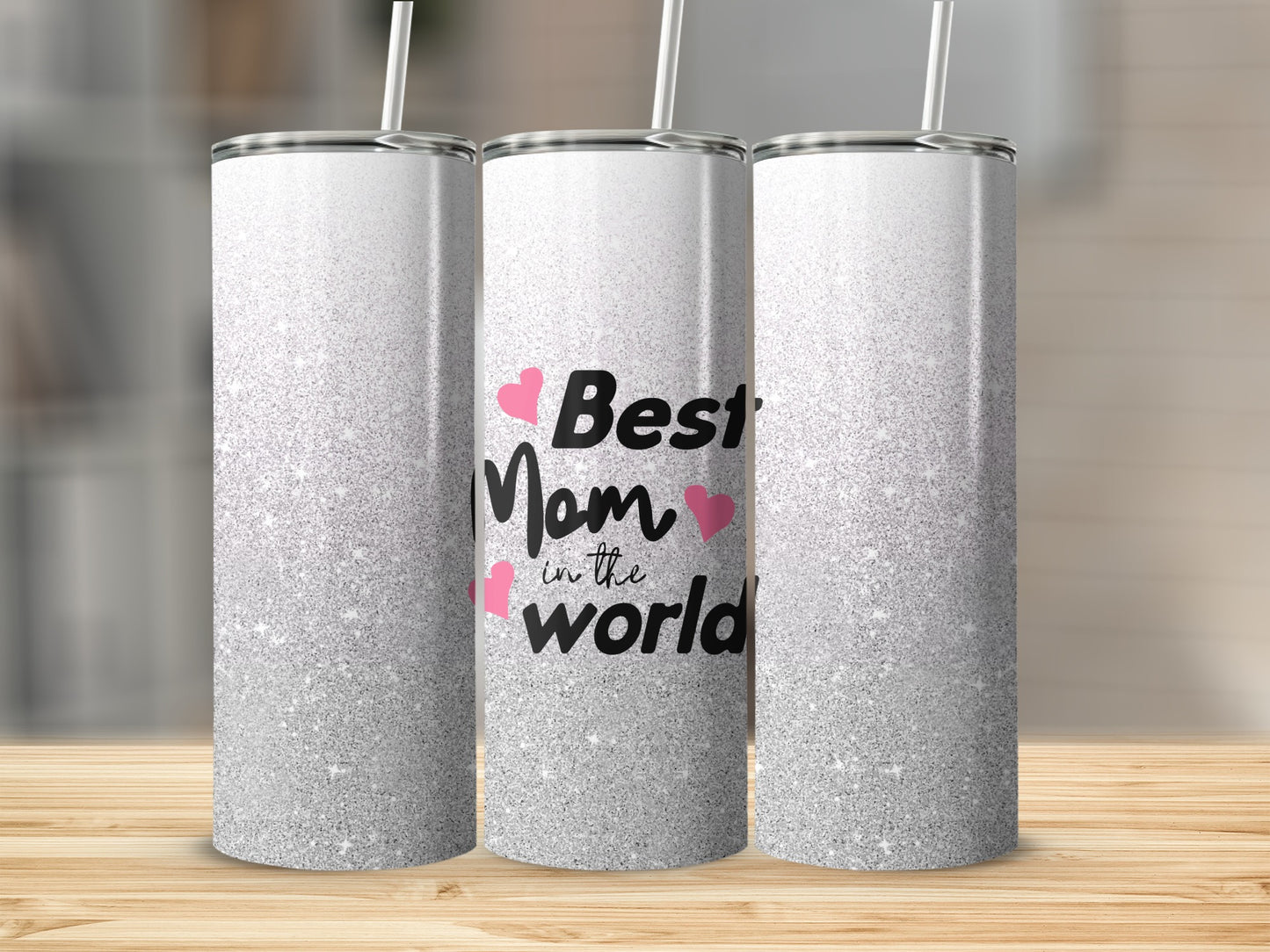 Silver glitter tumbler with "Best mom in the world" text and pink hearts.