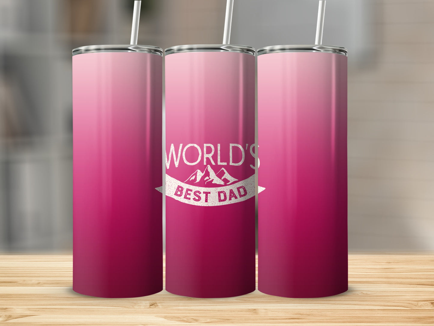 Pink gradient tumbler with "World's Best Dad" text and mountain graphic.