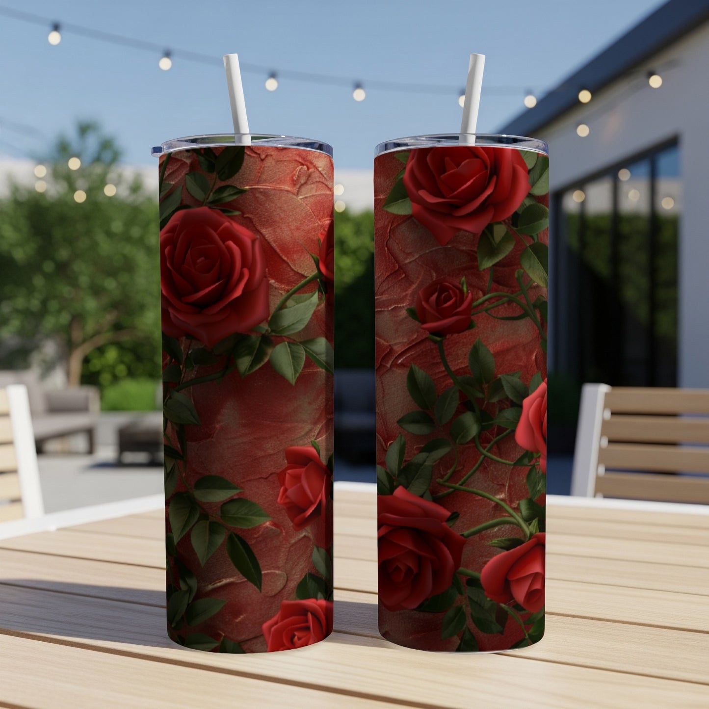 Two tall tumblers with red roses and green leaves on textured background.