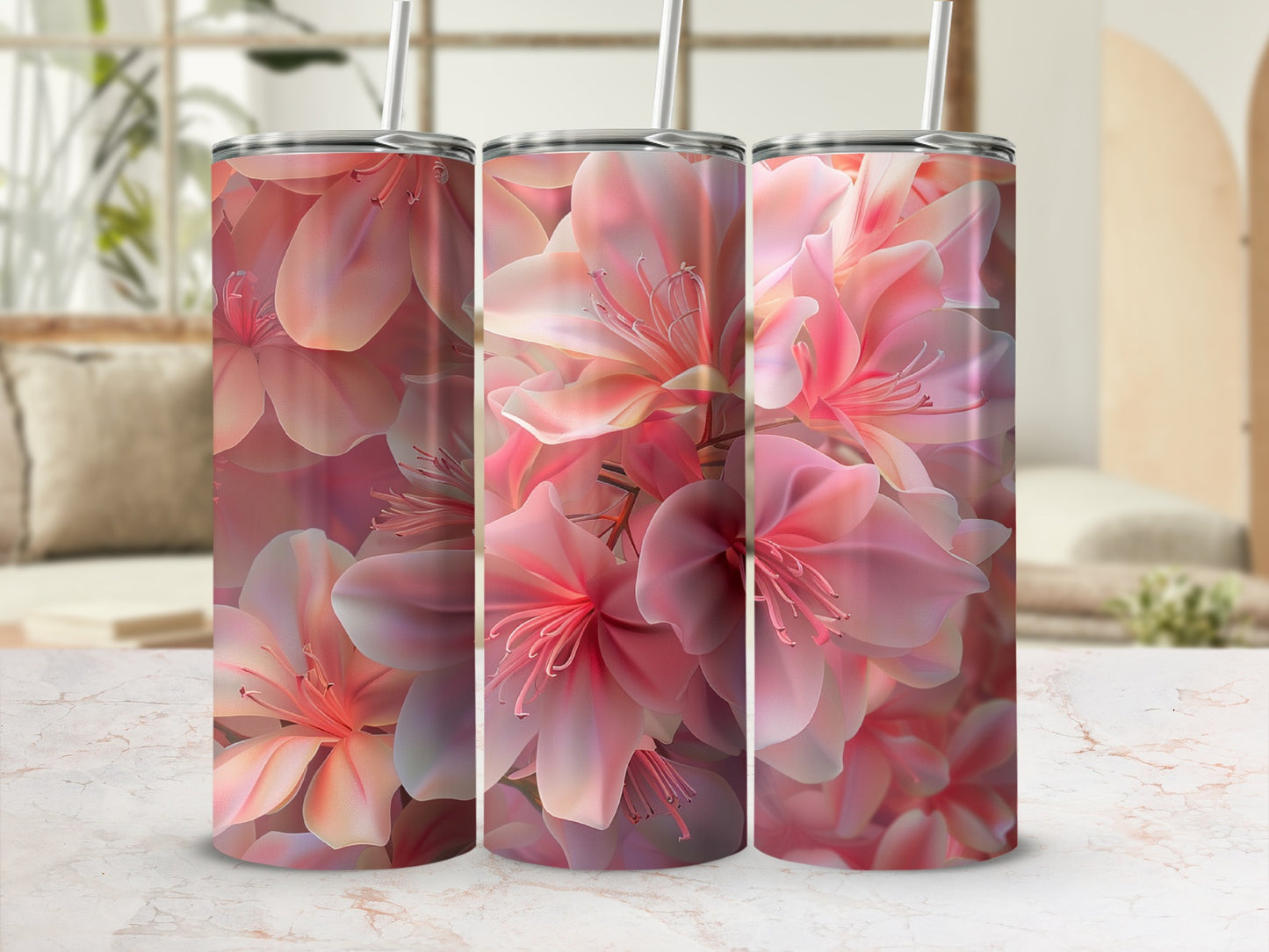 Three tumblers with a pink floral pattern on a marble surface.