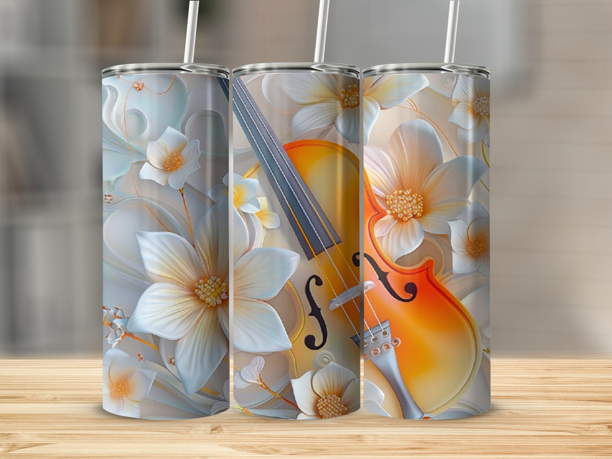 Violin and floral pattern on three tall, insulated tumblers.