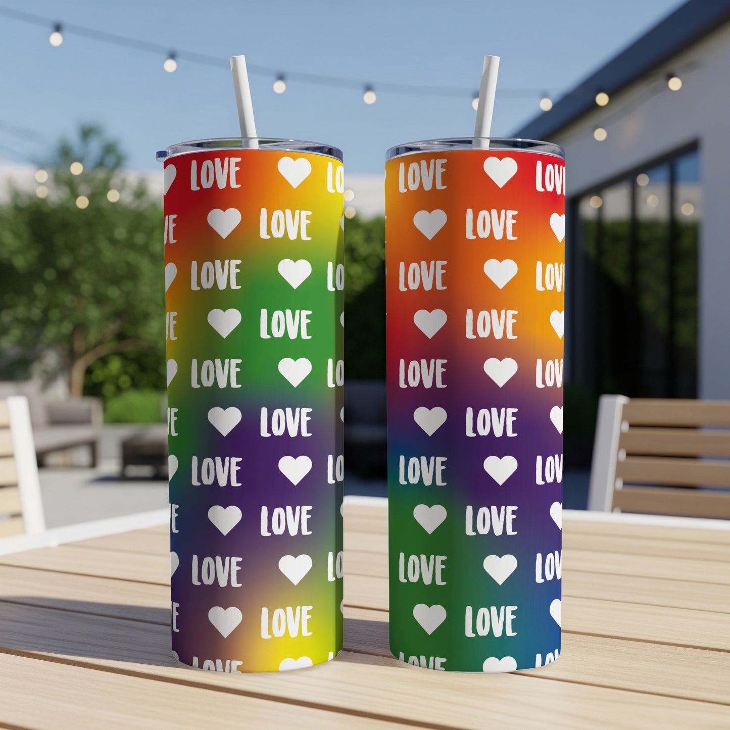 Two pride flag colored tumblers with "LOVE" repeated in white hearts.