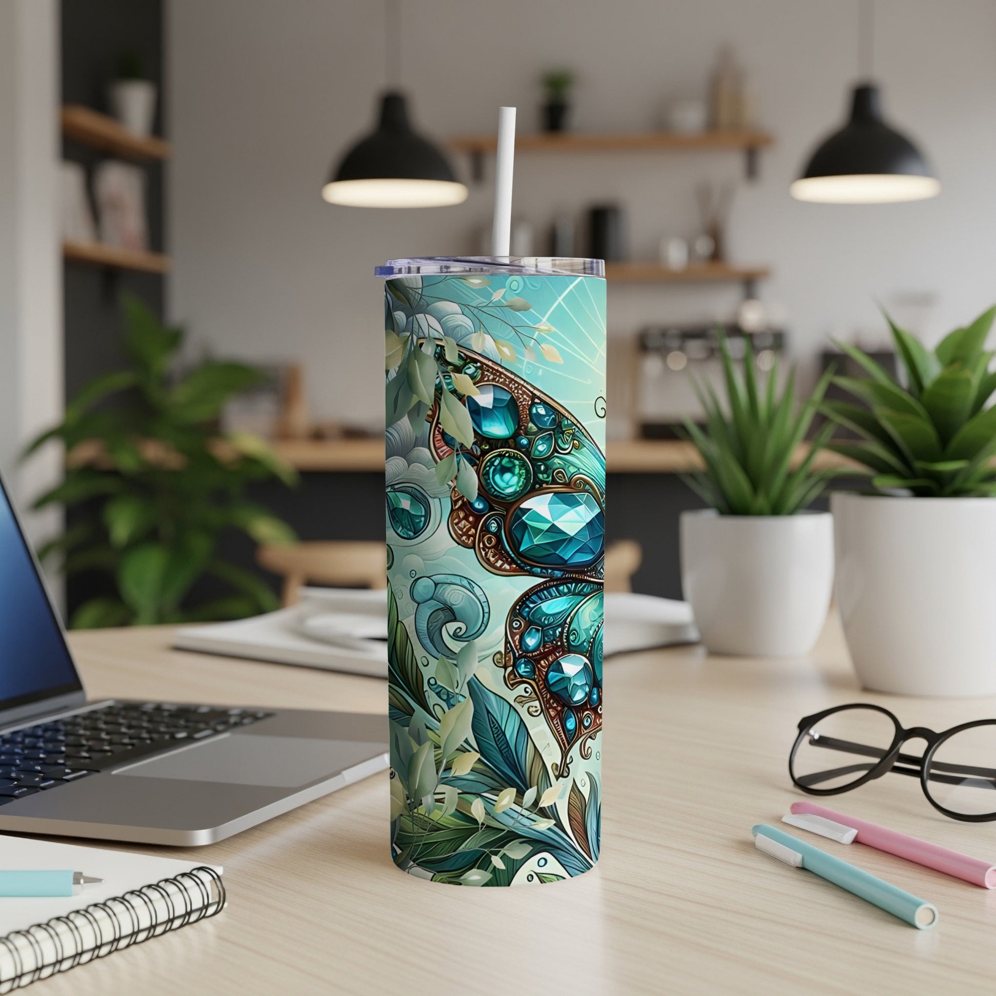 Teal tumbler with butterfly and floral design, white straw.
