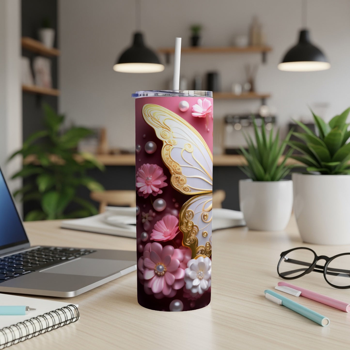 Pink tumbler with butterfly wings and floral accents.