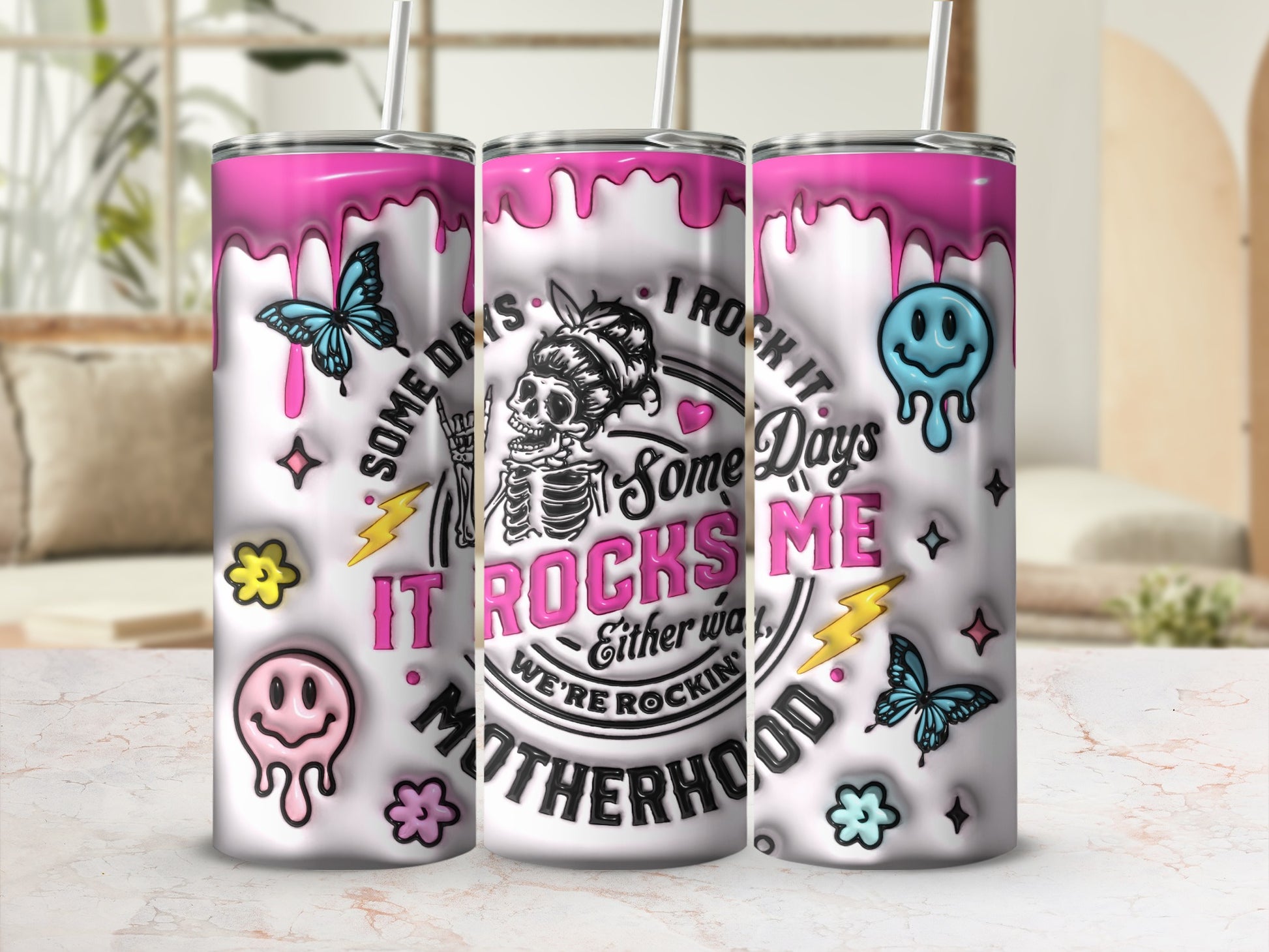 Tumbler featuring dripping pink skulls, butterflies, and "It Rocks Me Motherhood" text.