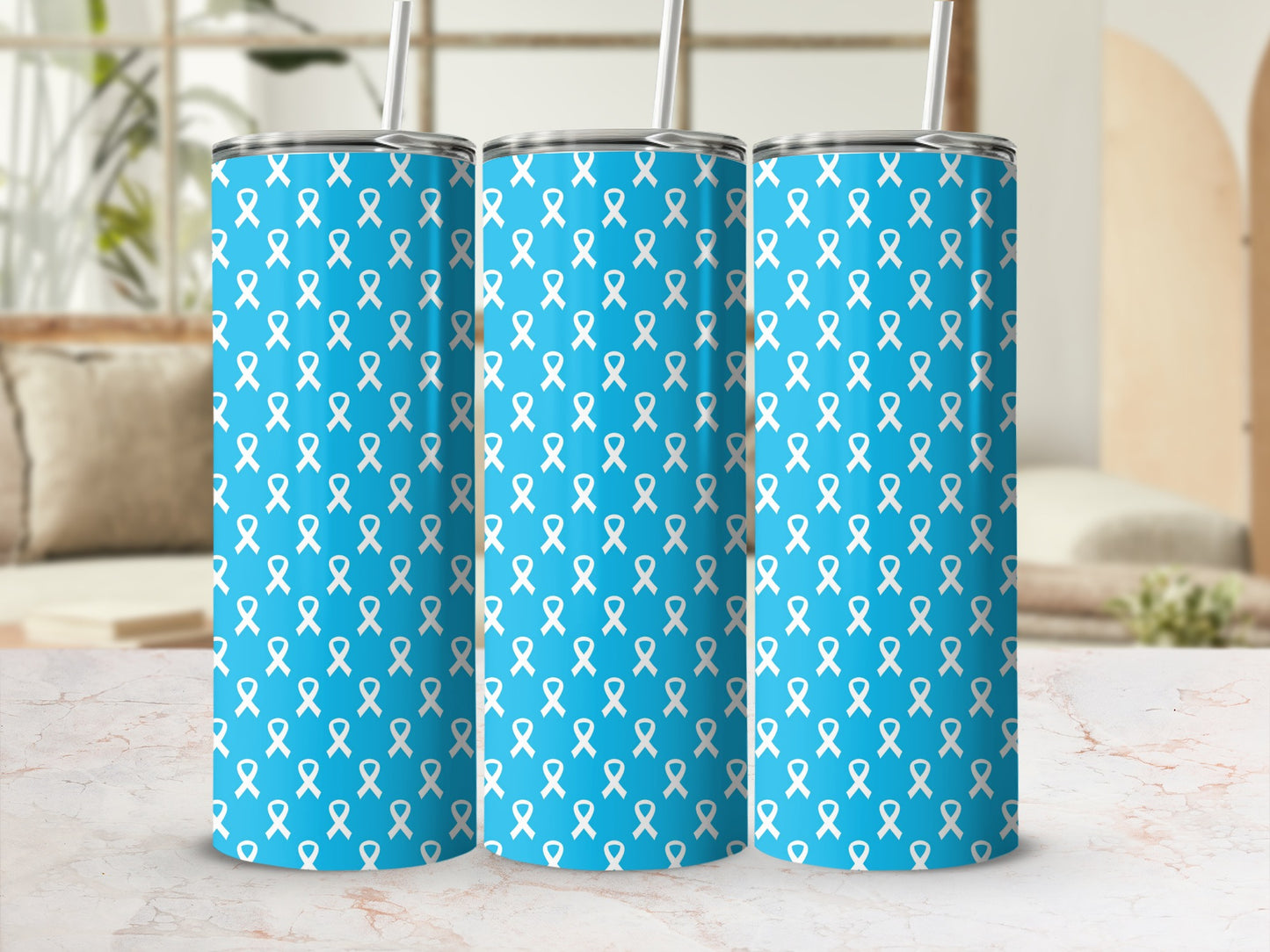 Three blue tumblers with a white ribbon pattern and silver straws.