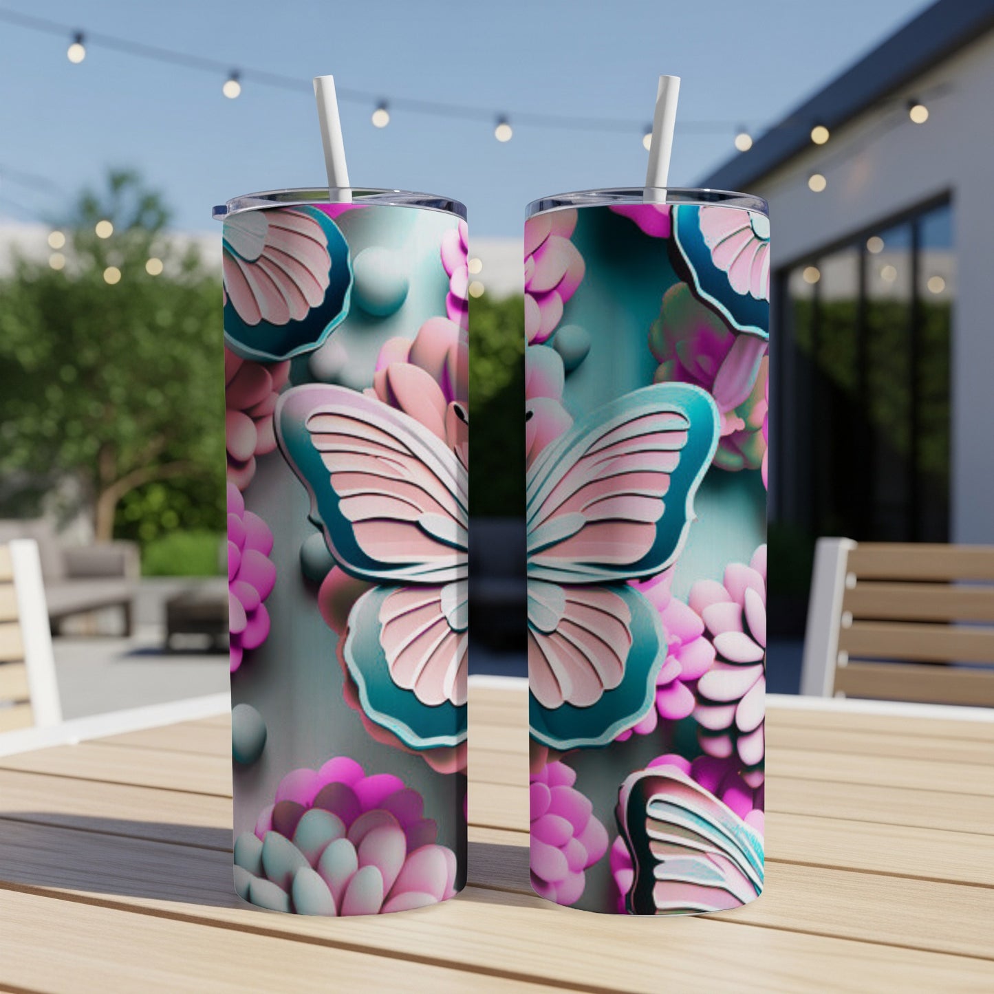 Two tumblers with a butterfly and floral design sit on a wooden table.