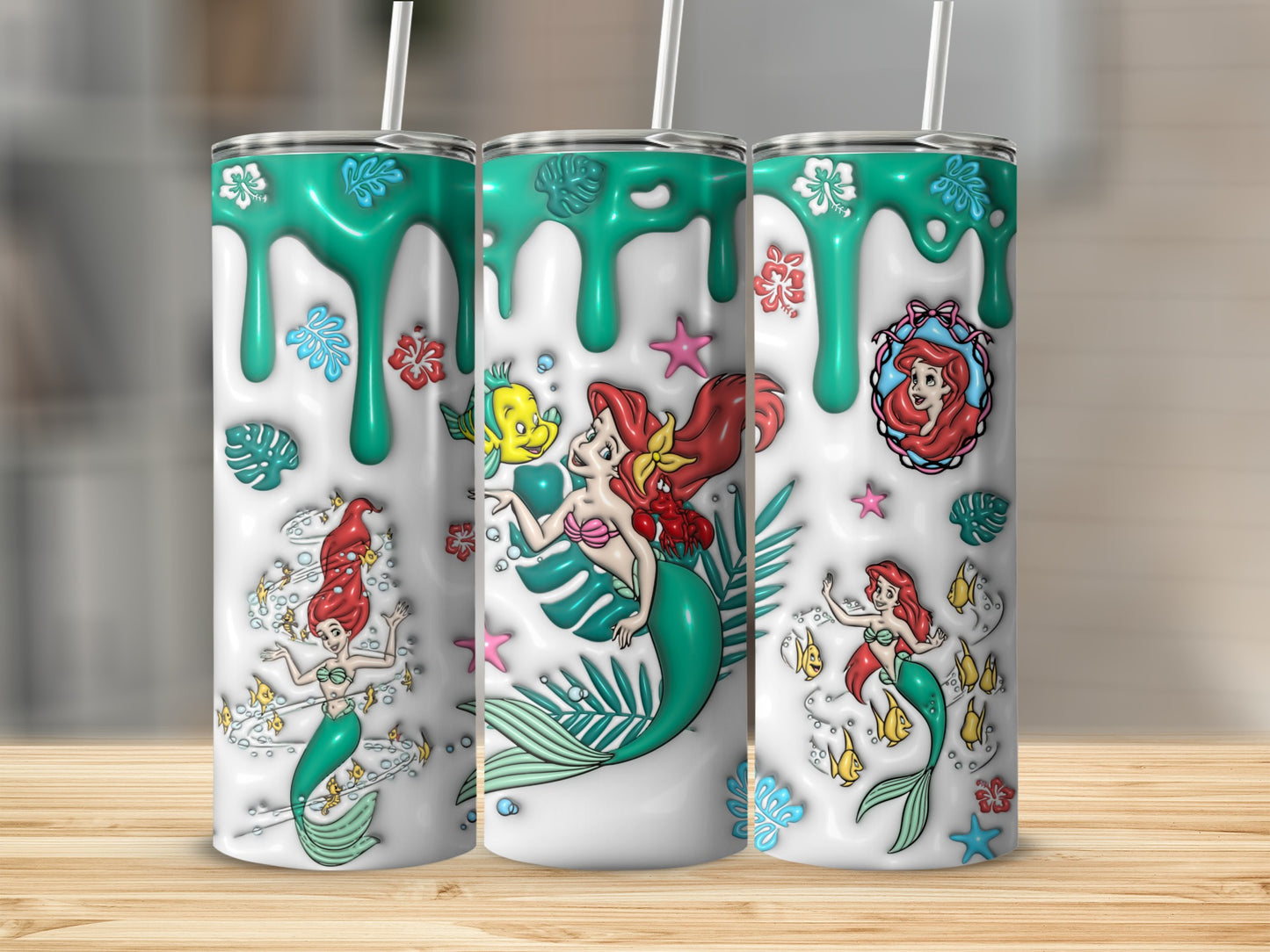 Three tumblers with Ariel from The Little Mermaid in different poses.