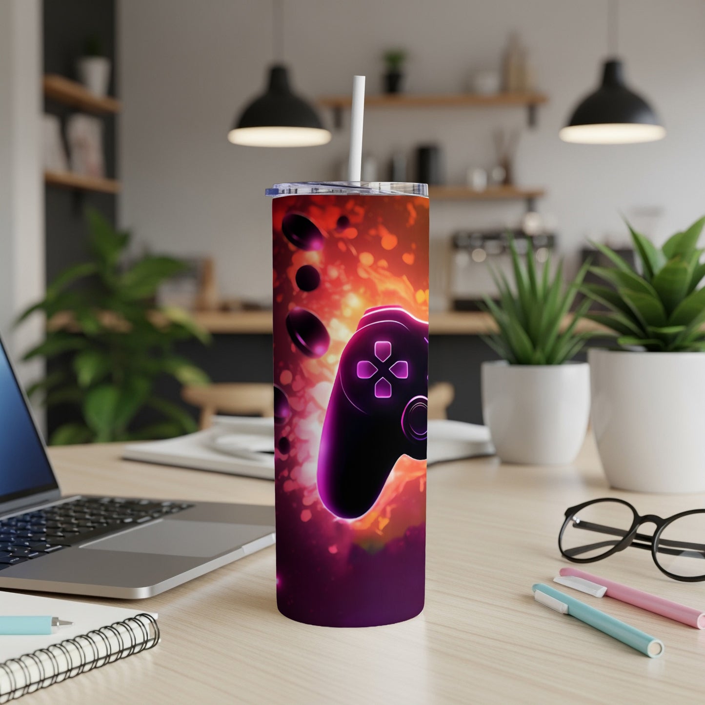 Purple video game controller graphic on a dark, fiery patterned tumbler with a straw.