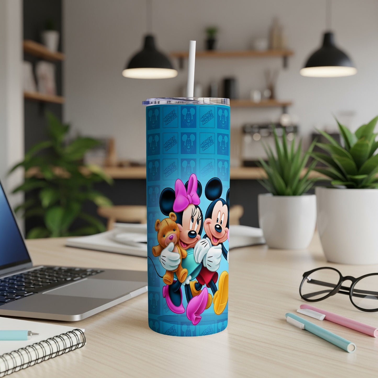 Minnie and Mickey Mouse hug holding a teddy bear on a blue tumbler.