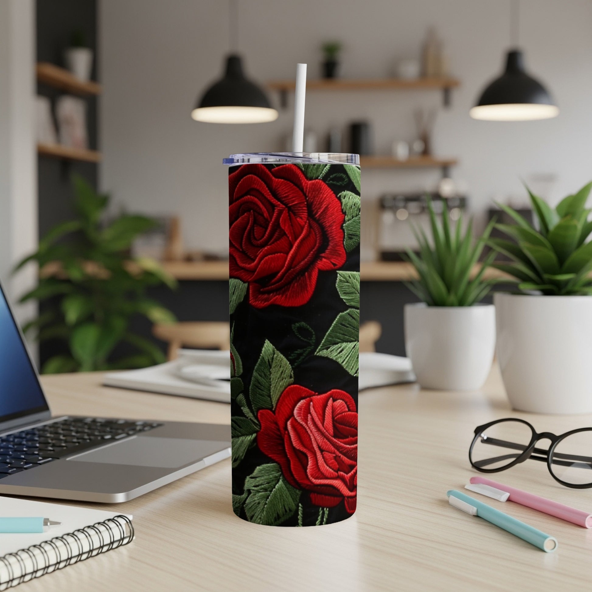 Black tumbler with red embroidered roses and green leaves design.
