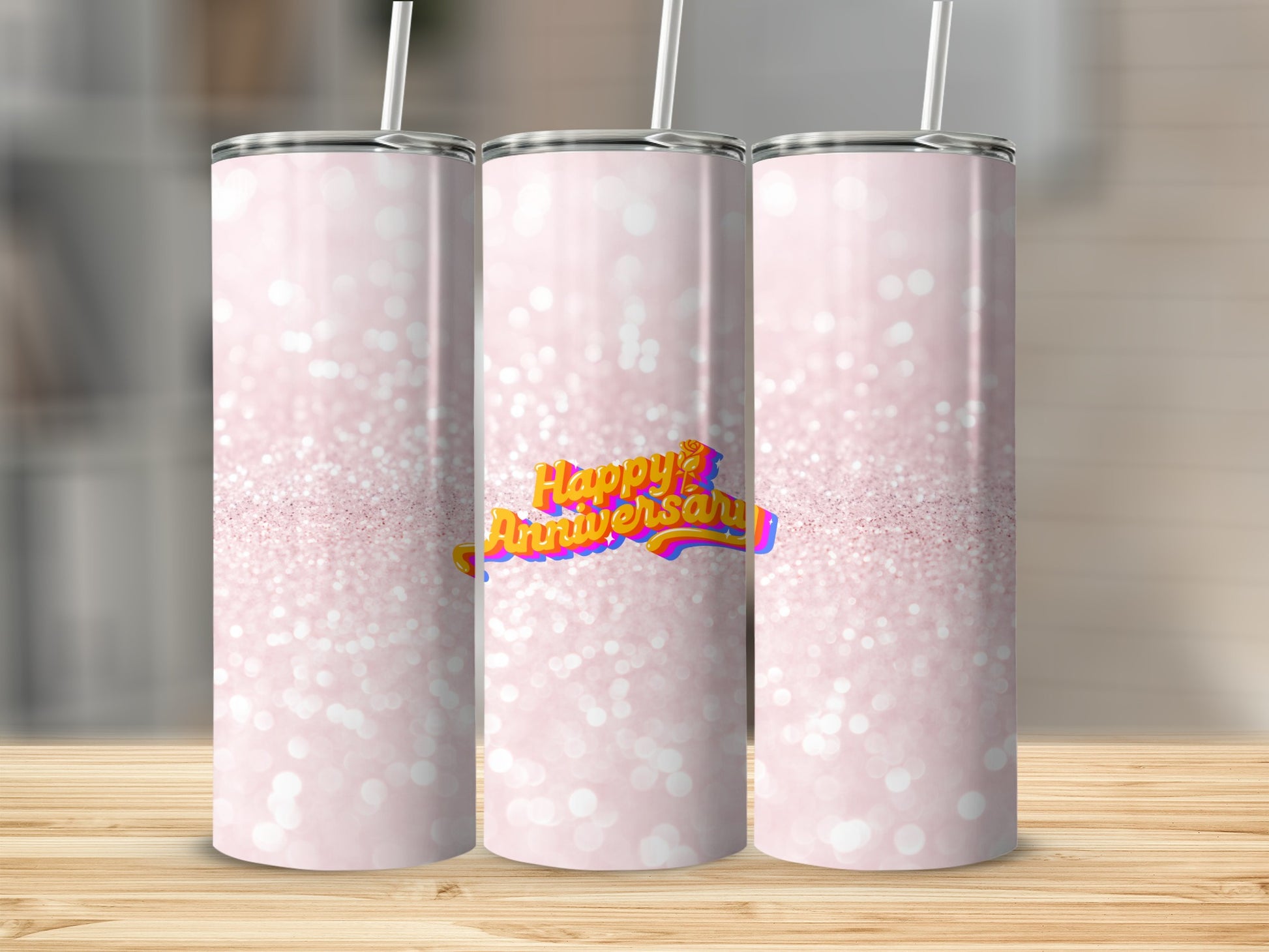 Three pink glitter tumblers with "Happy Anniversary" text on the center one.