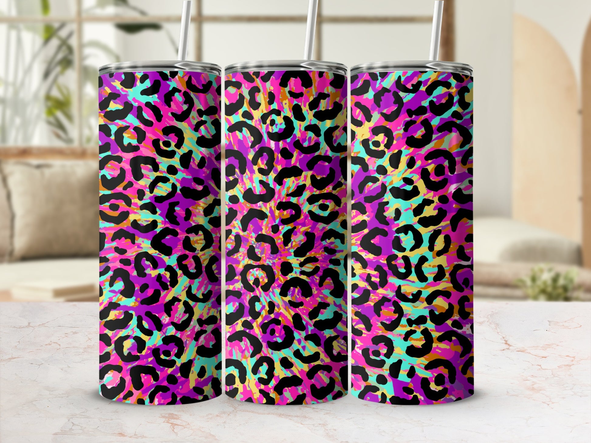 Three tumblers with a vibrant pink, purple, teal, and yellow leopard print design.