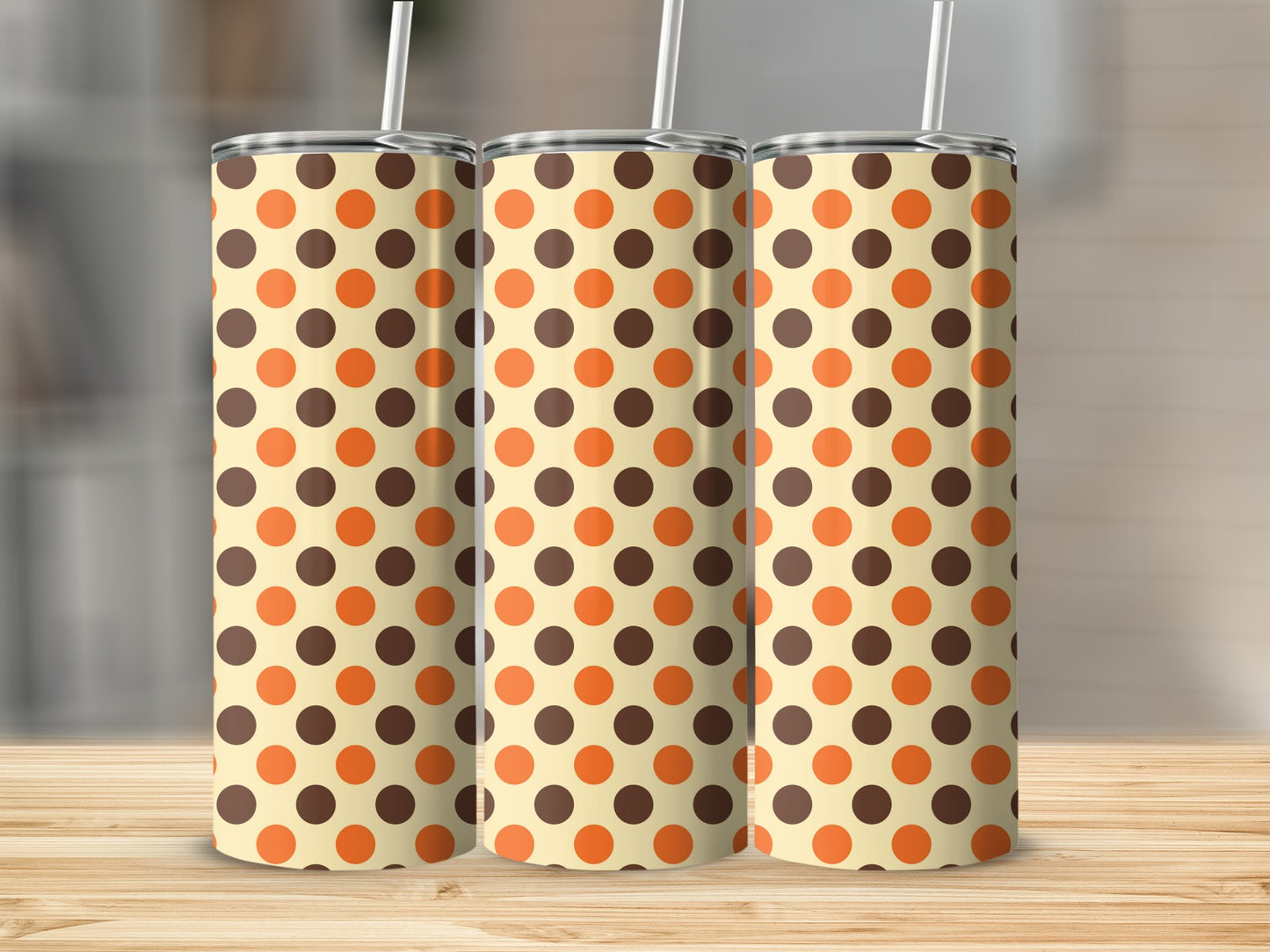 Three tumblers with a cream background and brown and orange polka dot pattern.