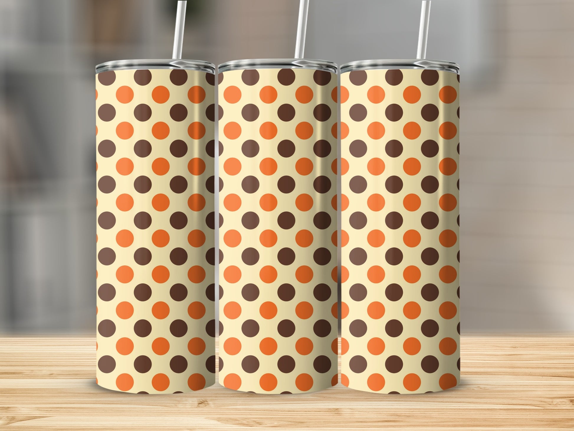 Three tumblers with a cream background and brown and orange polka dot pattern.