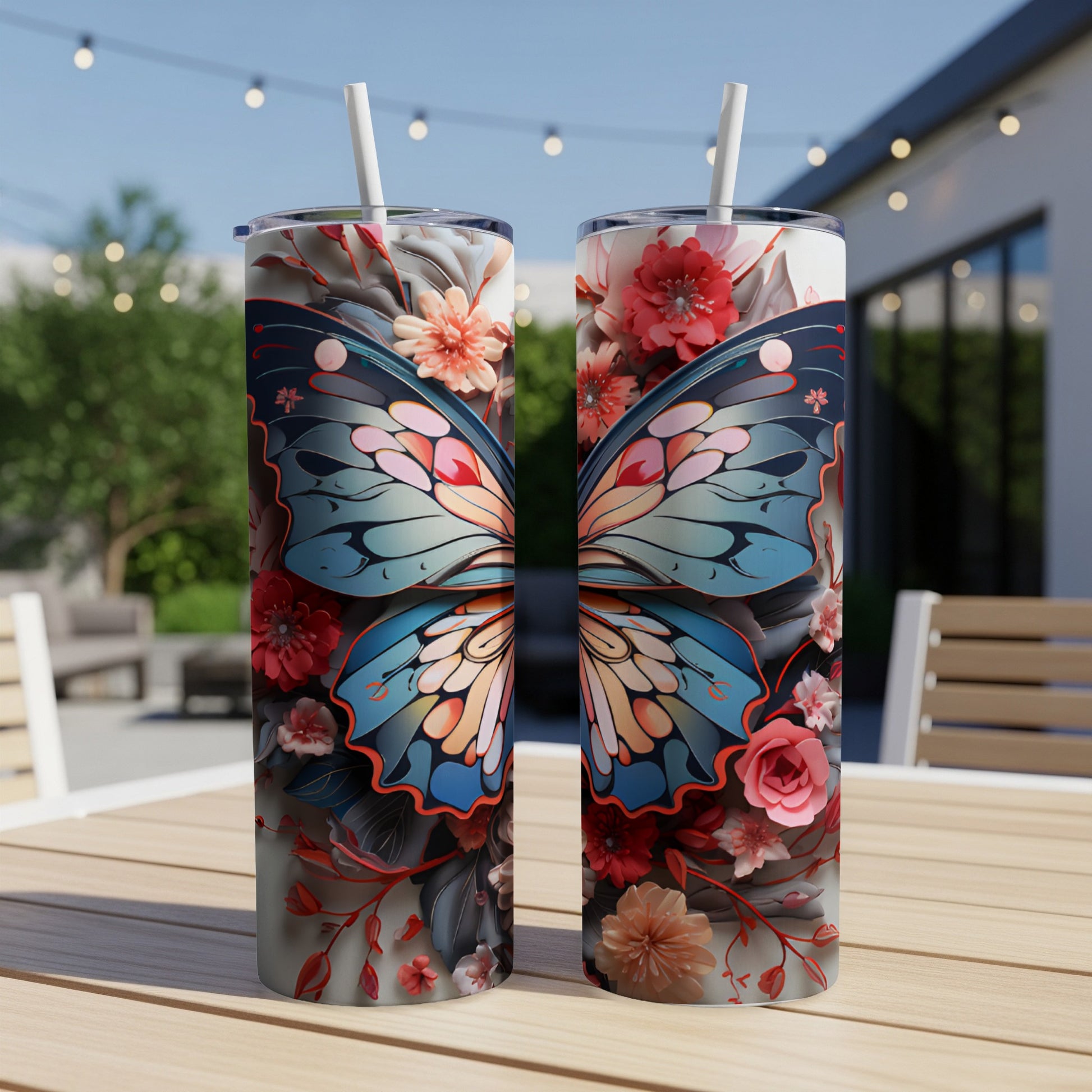 Two tumblers with butterfly and floral designs sit on a wooden table.