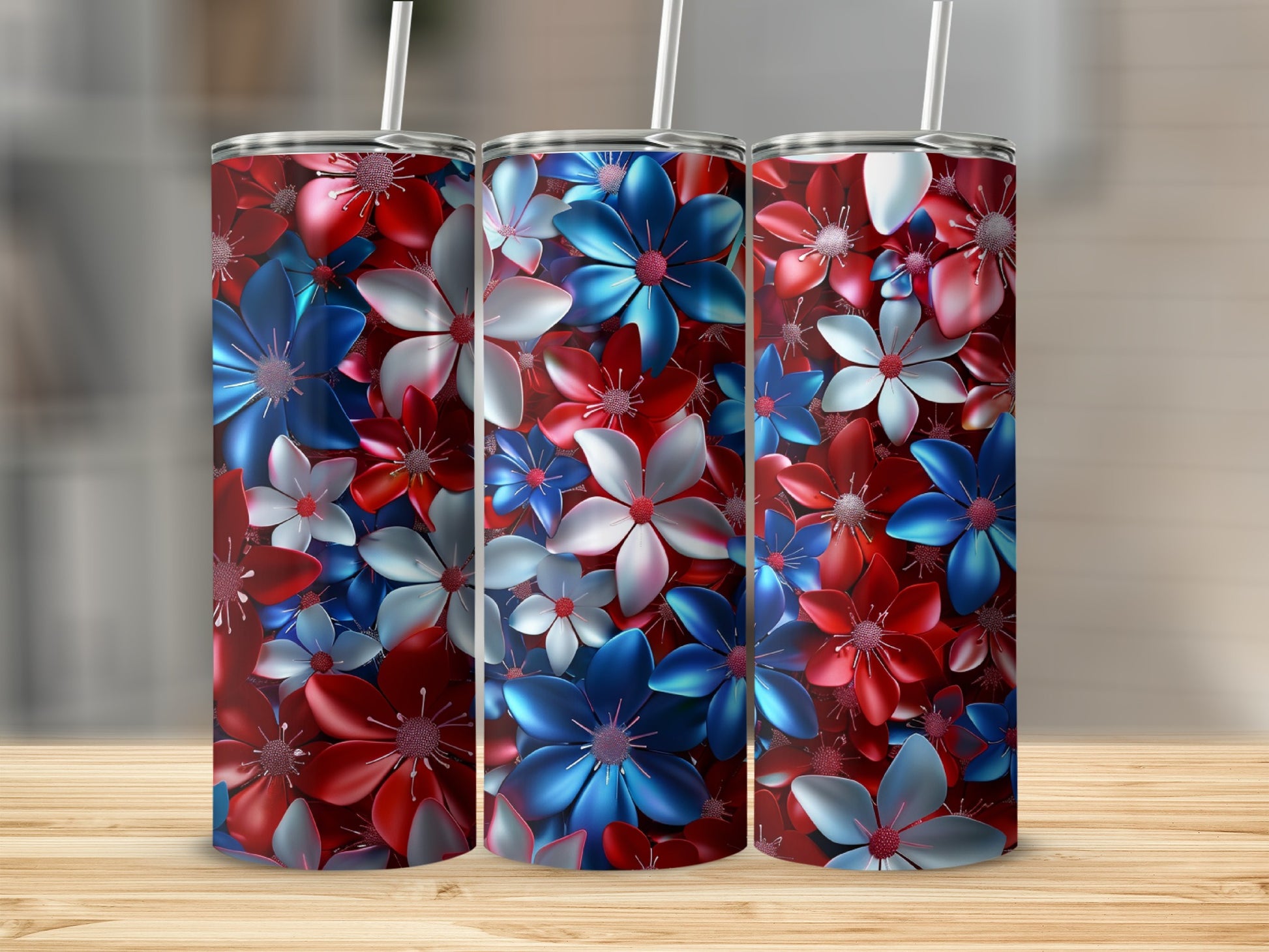 Red, white, and blue floral pattern on three tumblers with straws.