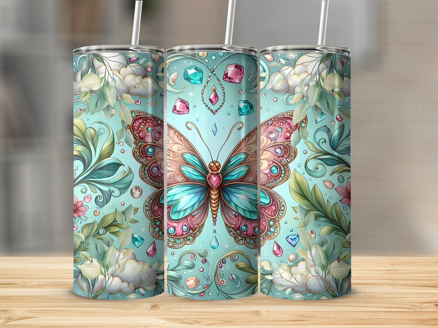 Three tumblers featuring a pastel butterfly with jewel accents and floral details.