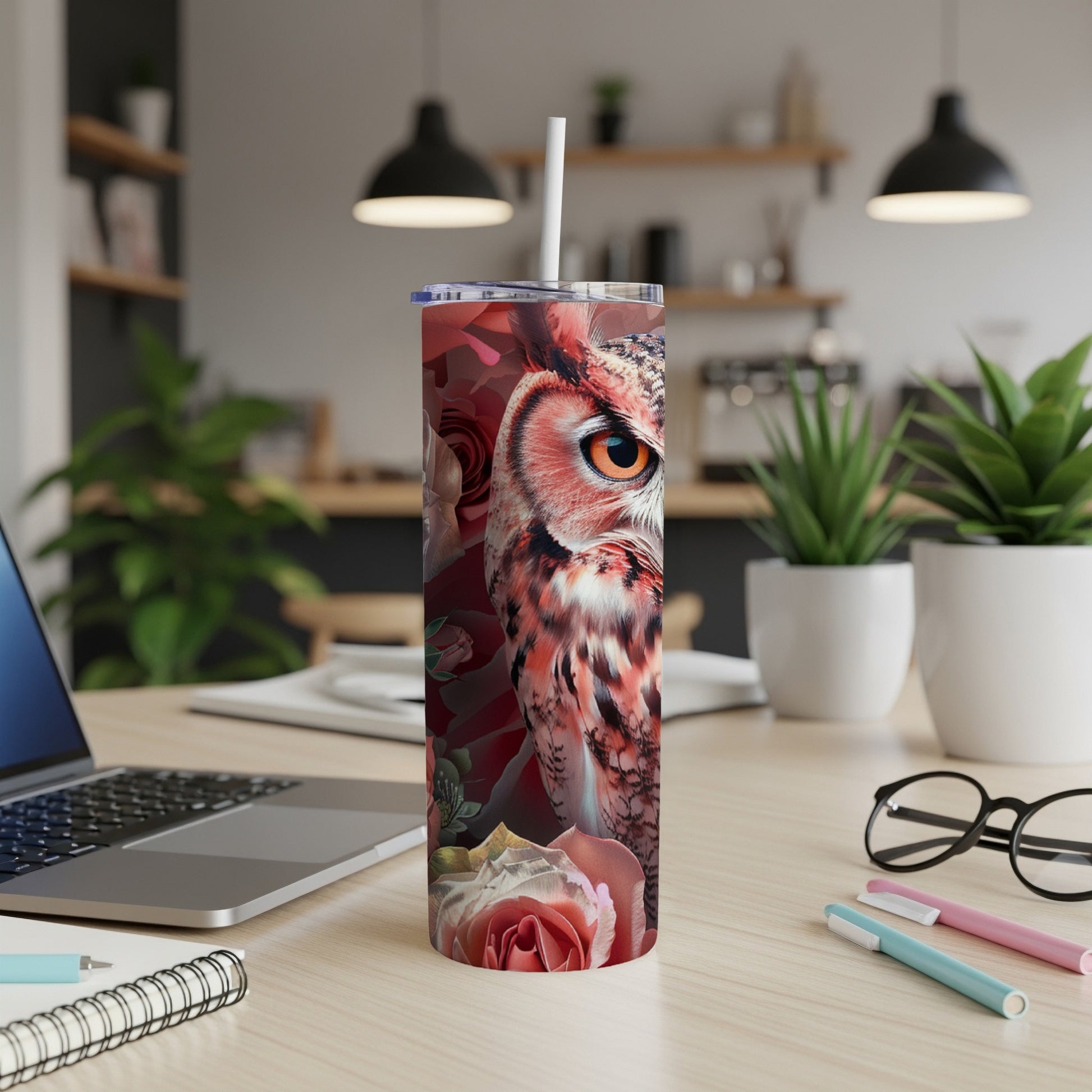Red rose and owl artwork on a white tumbler with a straw.