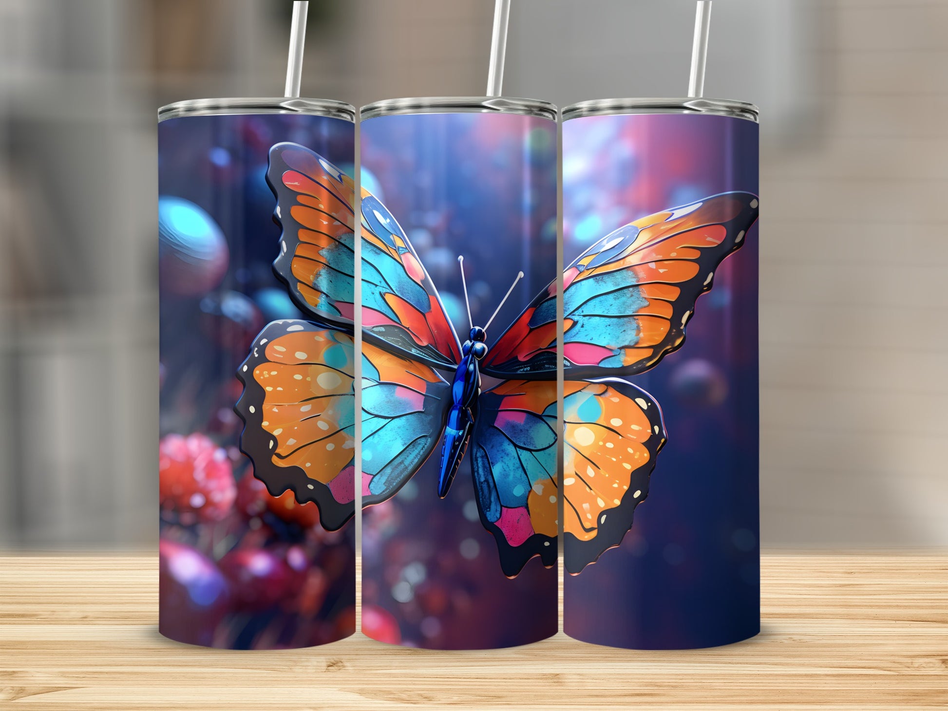 Three tumblers featuring a vibrant butterfly design, placed on a wooden surface.