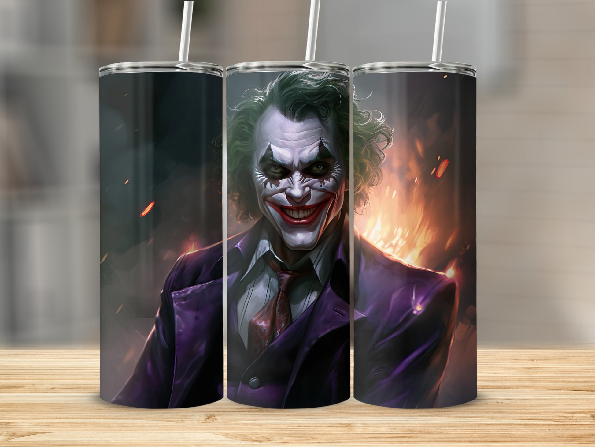 Joker artwork on three tumblers with straws, set against a fiery background.