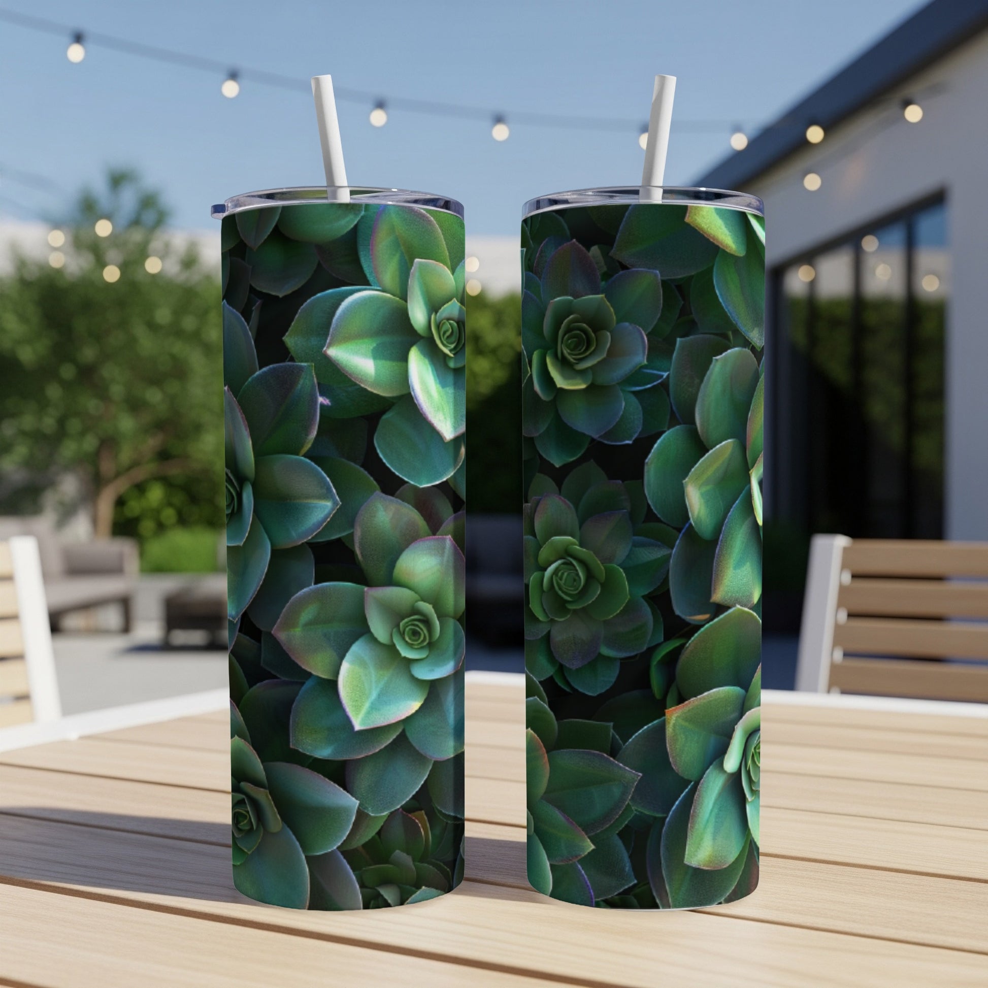 Two tumblers with a close-up succulent plant pattern on an outdoor table.