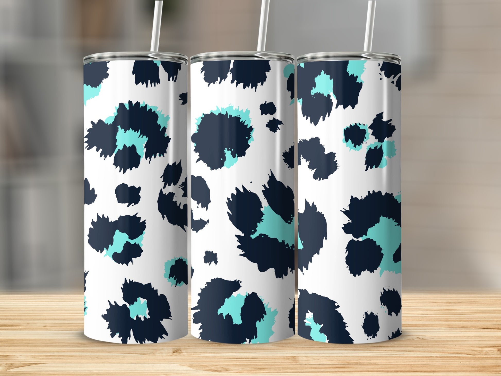 Three tumblers with a white background and blue and teal leopard print pattern.