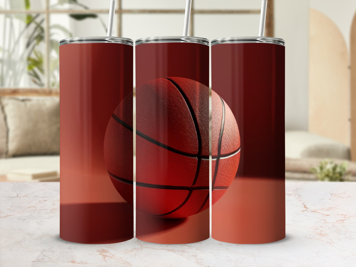 Three red tumblers with a basketball design, on a marble surface.