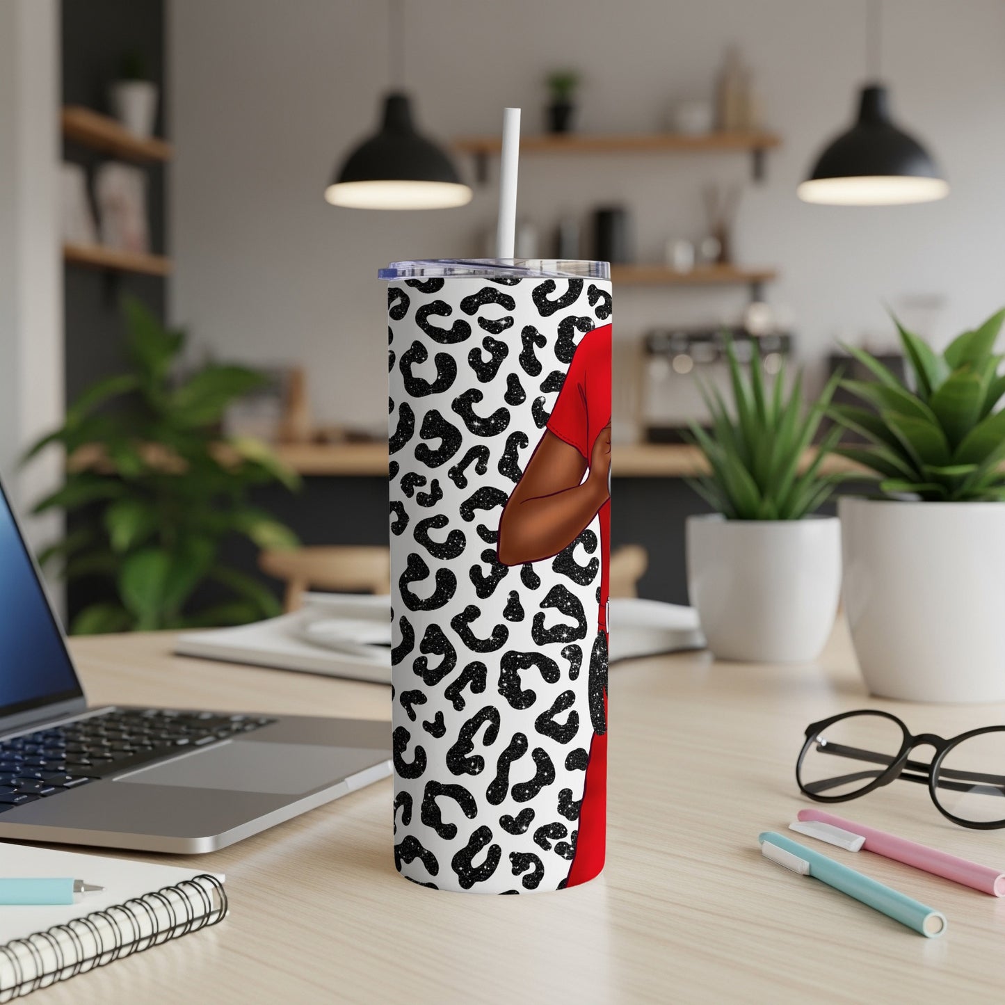 Red tumbler with leopard print and silhouette of a person.