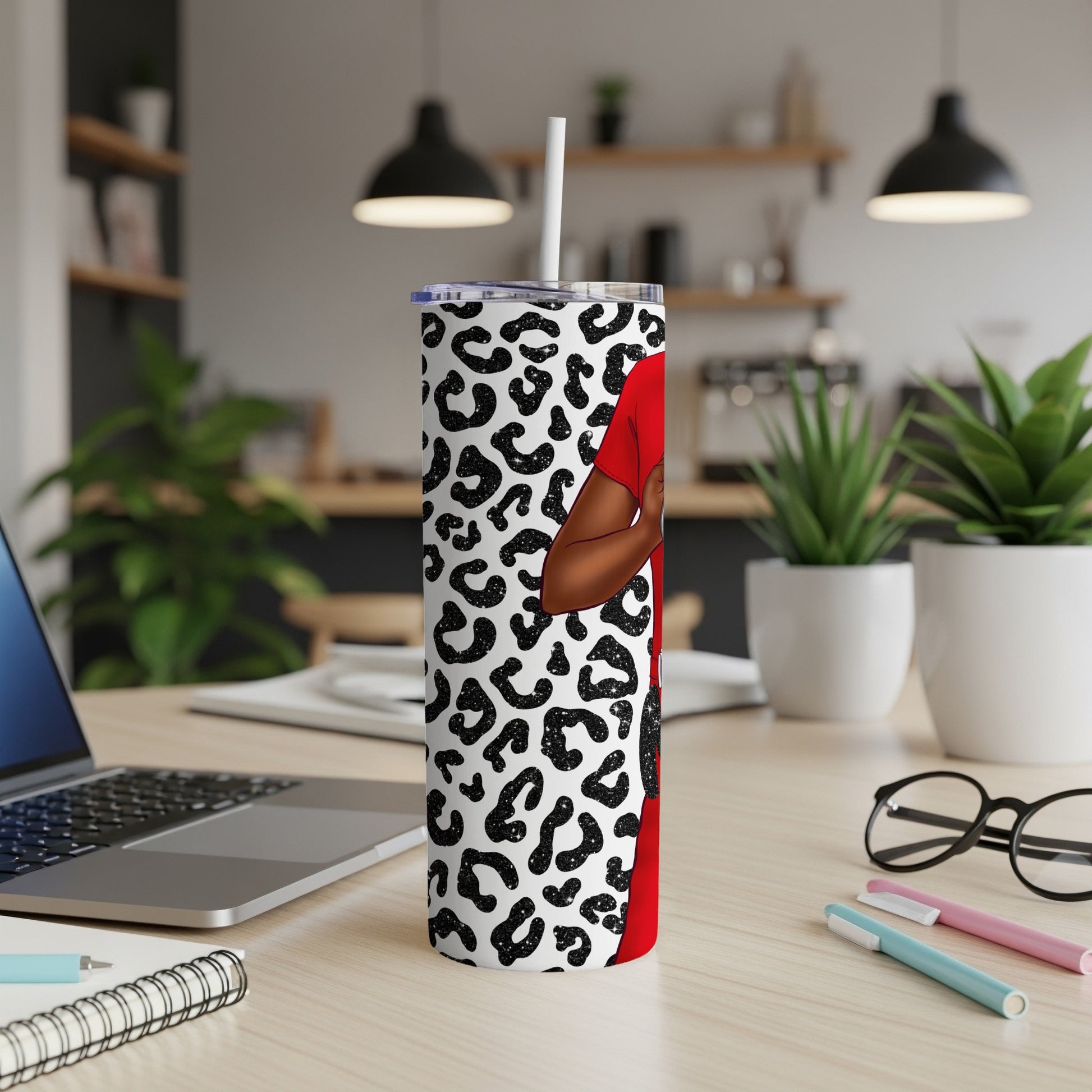Red tumbler with leopard print and silhouette of a person.