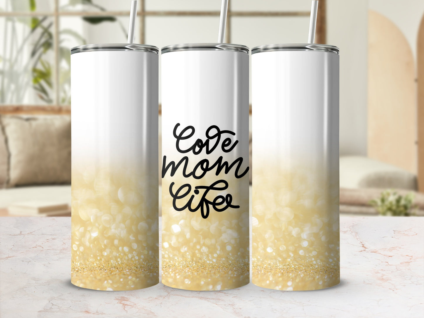 White tumbler with gold glitter and "Love mom life" text.