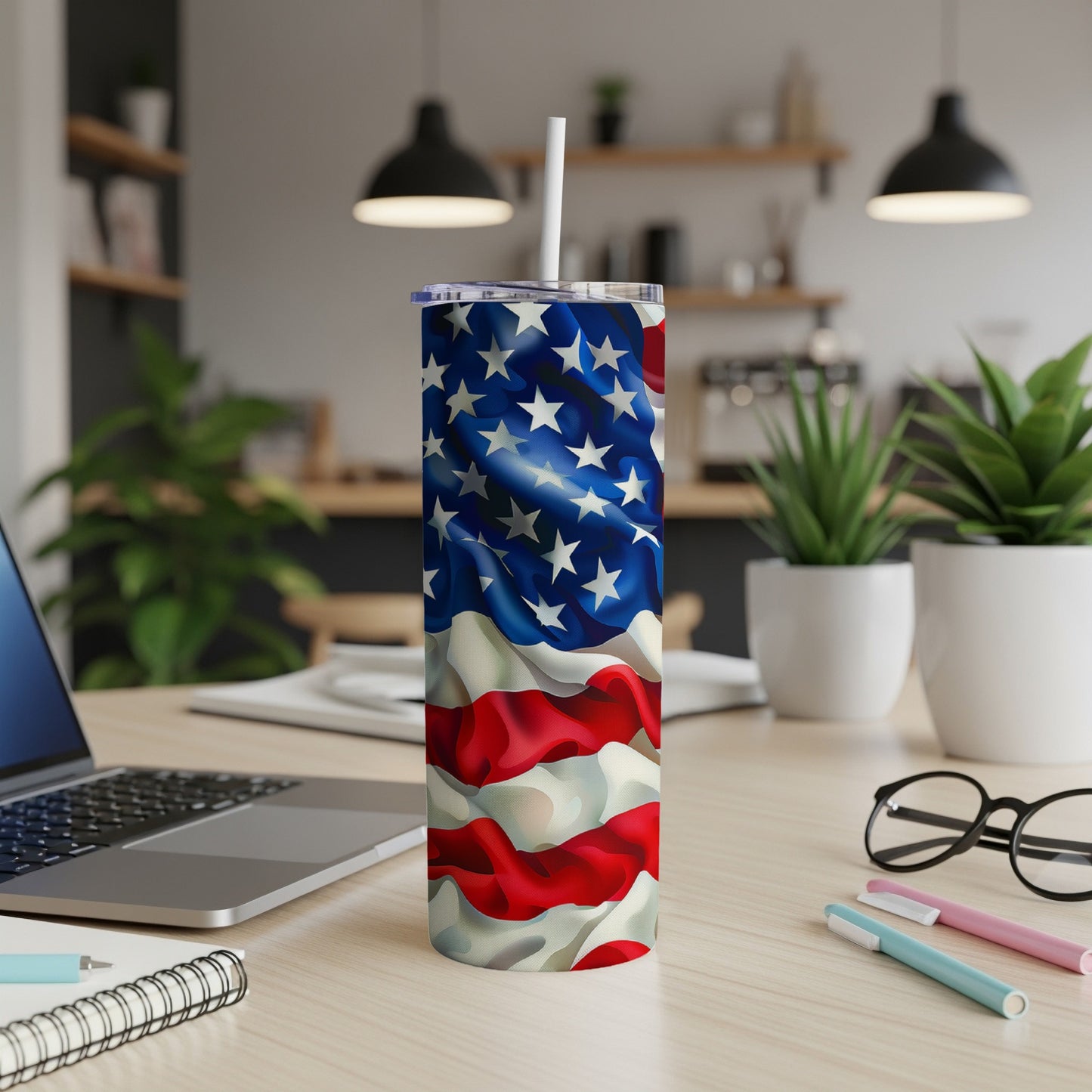 Tall tumbler with American flag design sits on a desk.