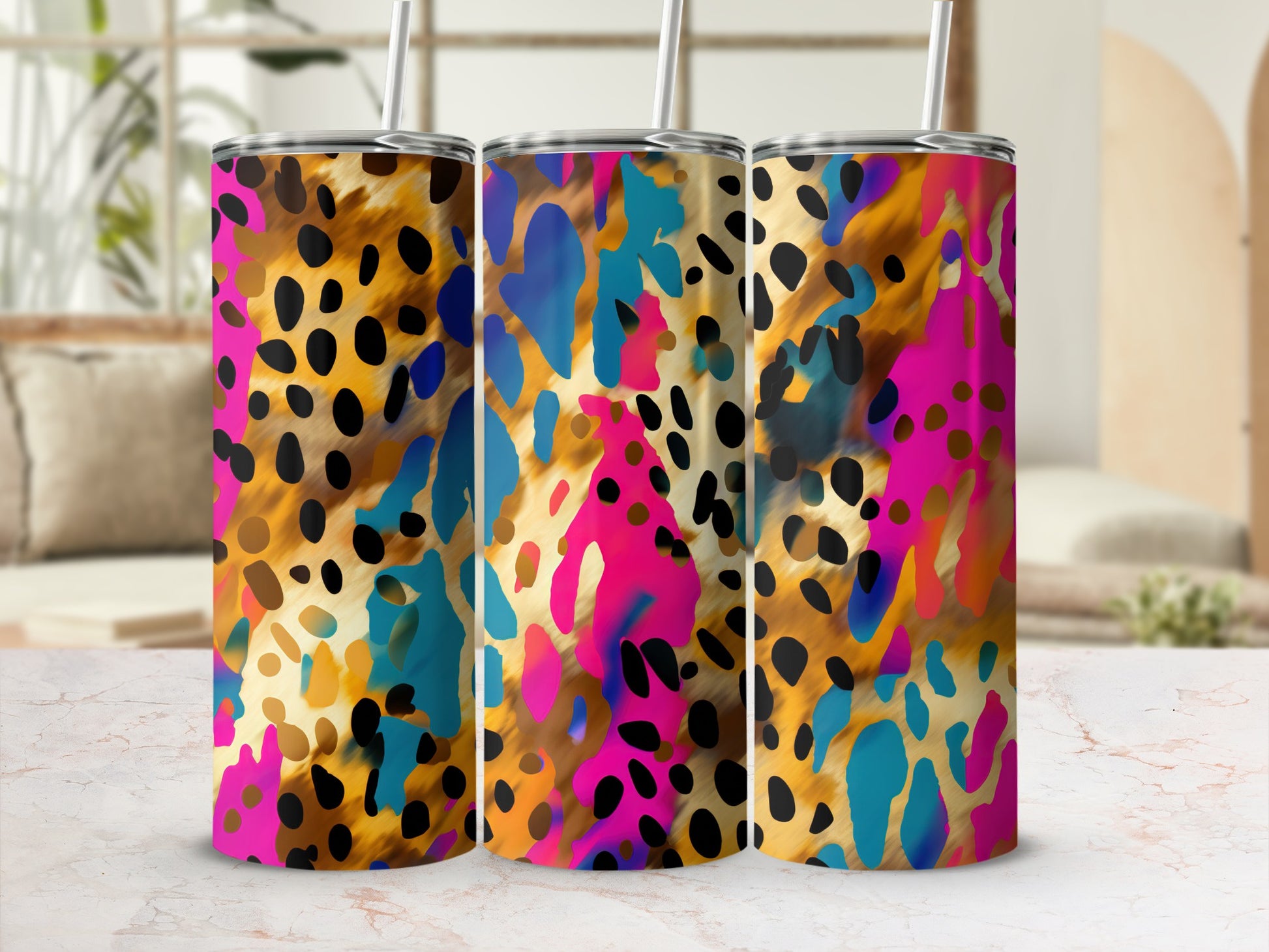 Three tumblers with a colorful leopard print pattern and straws.