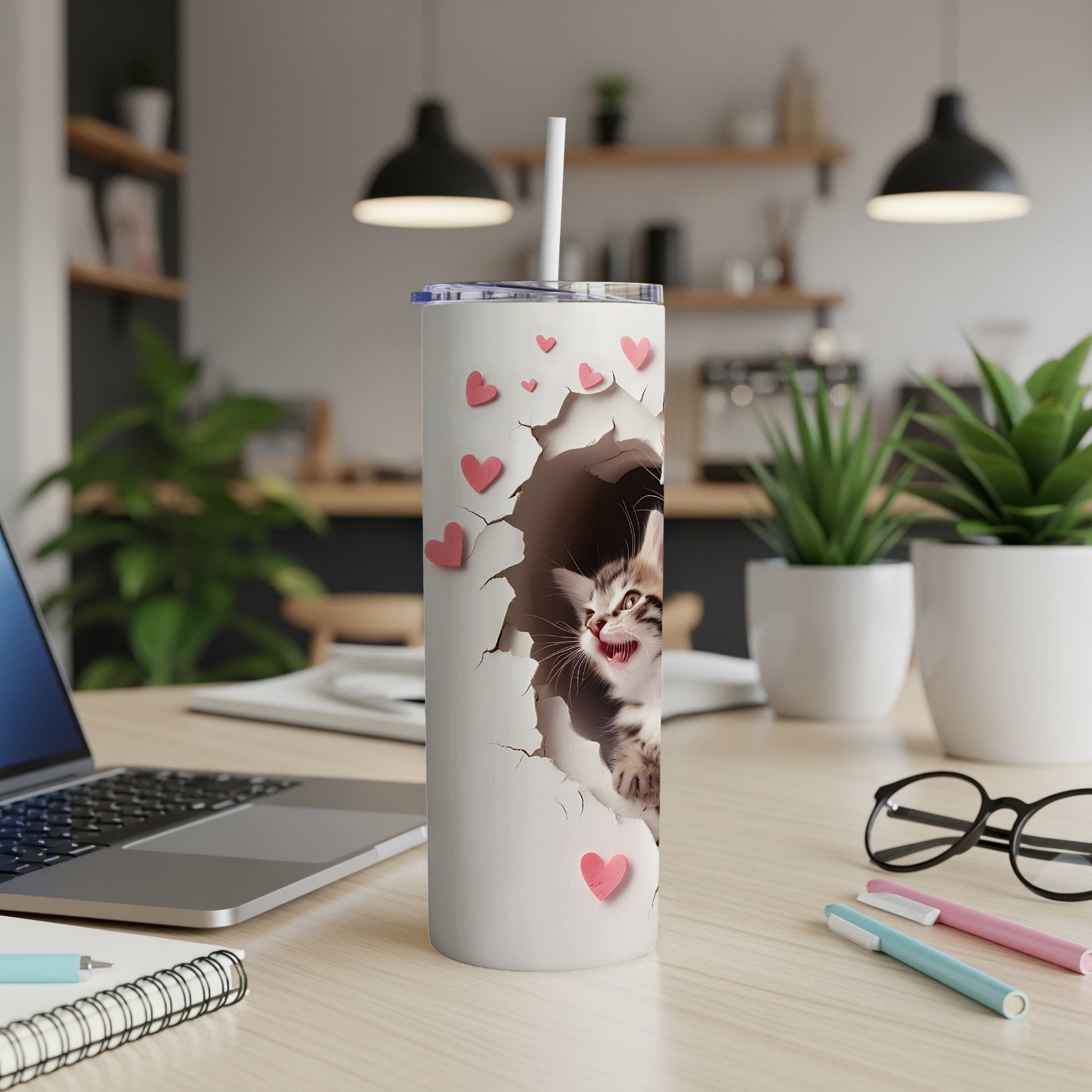 White tumbler with a kitten peeking through a torn opening and pink hearts.
