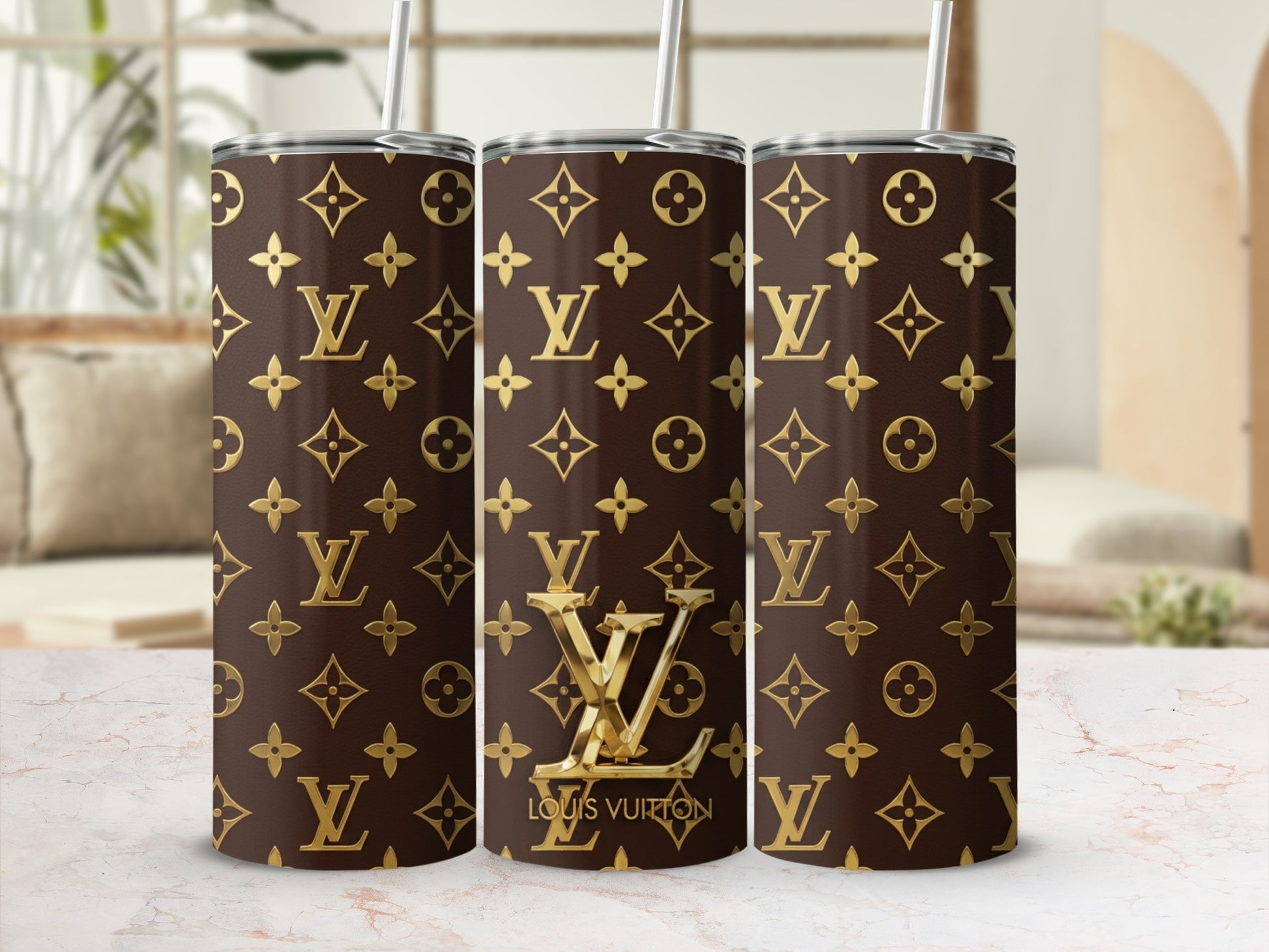Tumblers with a brown Louis Vuitton monogram pattern and gold accents.