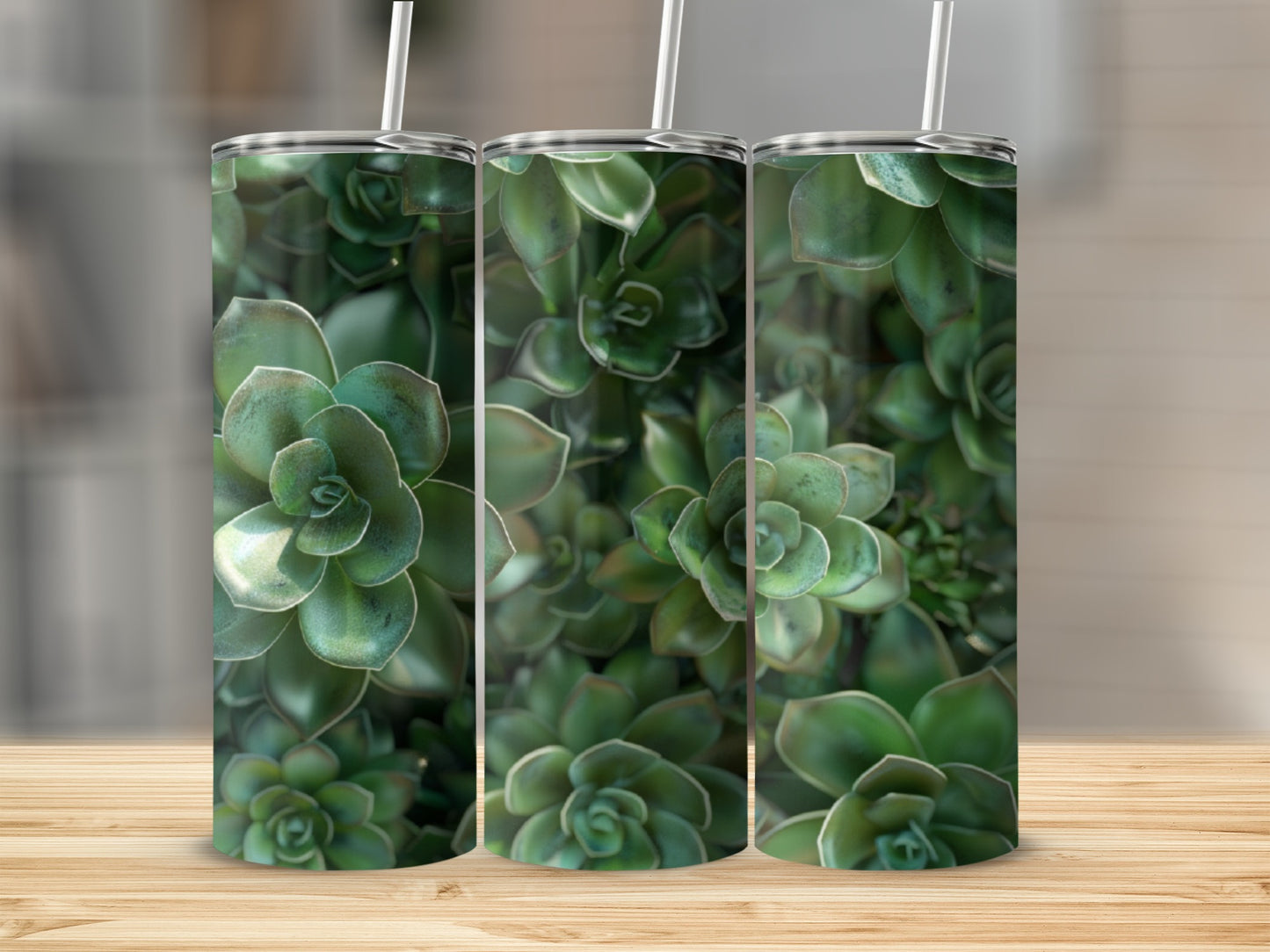 Three green succulent tumblers with straws on a wooden surface.