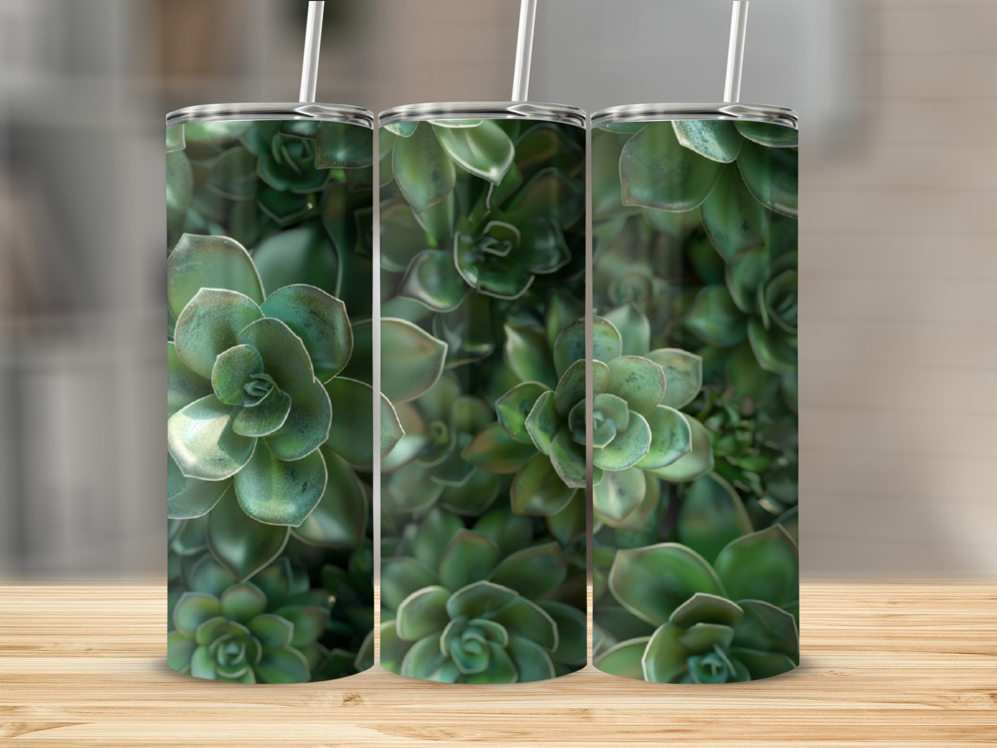 Three green succulent tumblers with straws on a wooden surface.