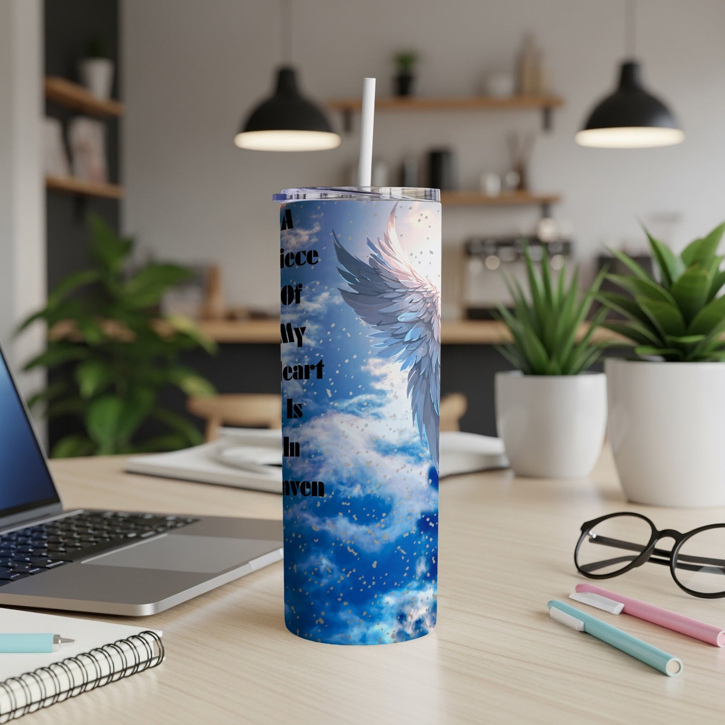 Angel wings and clouds design on a white tumbler with straw.