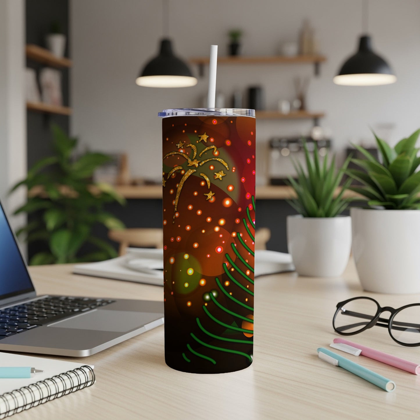 Christmas tree and fireworks design on a tumbler with a straw.