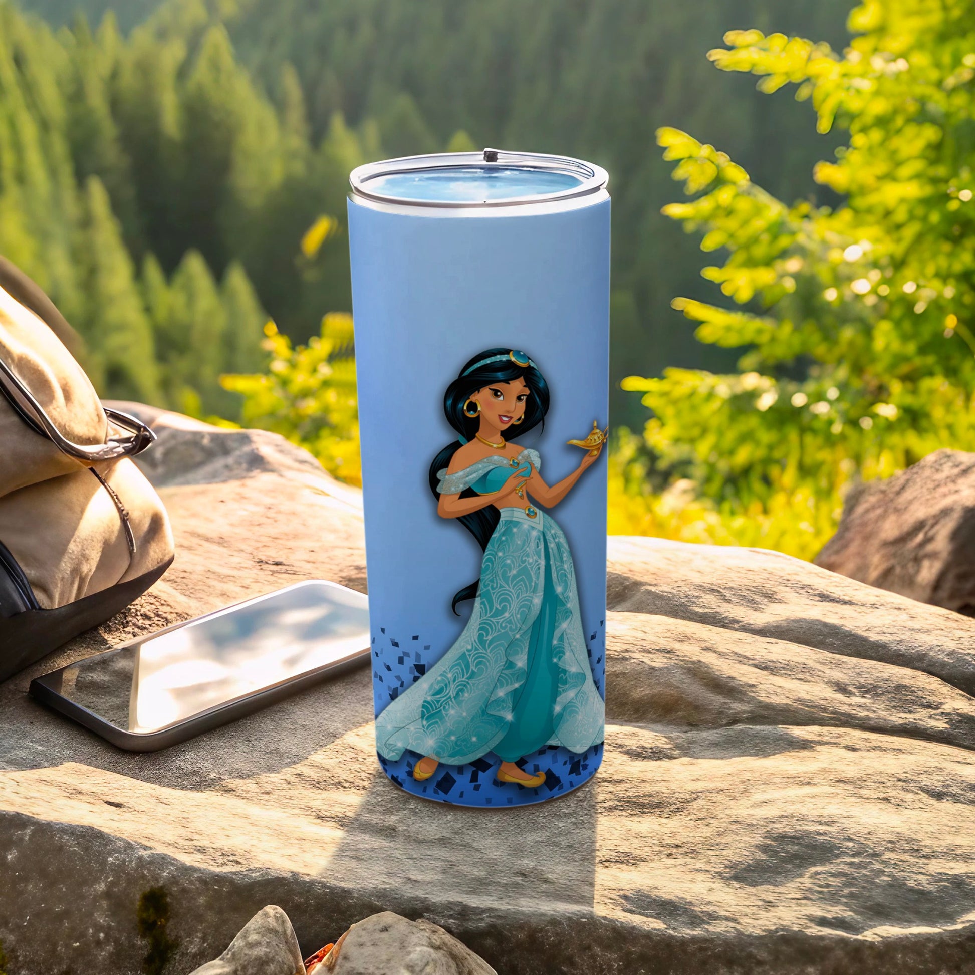 Light blue tumbler featuring Disney's Jasmine holding a golden lamp, placed outdoors.