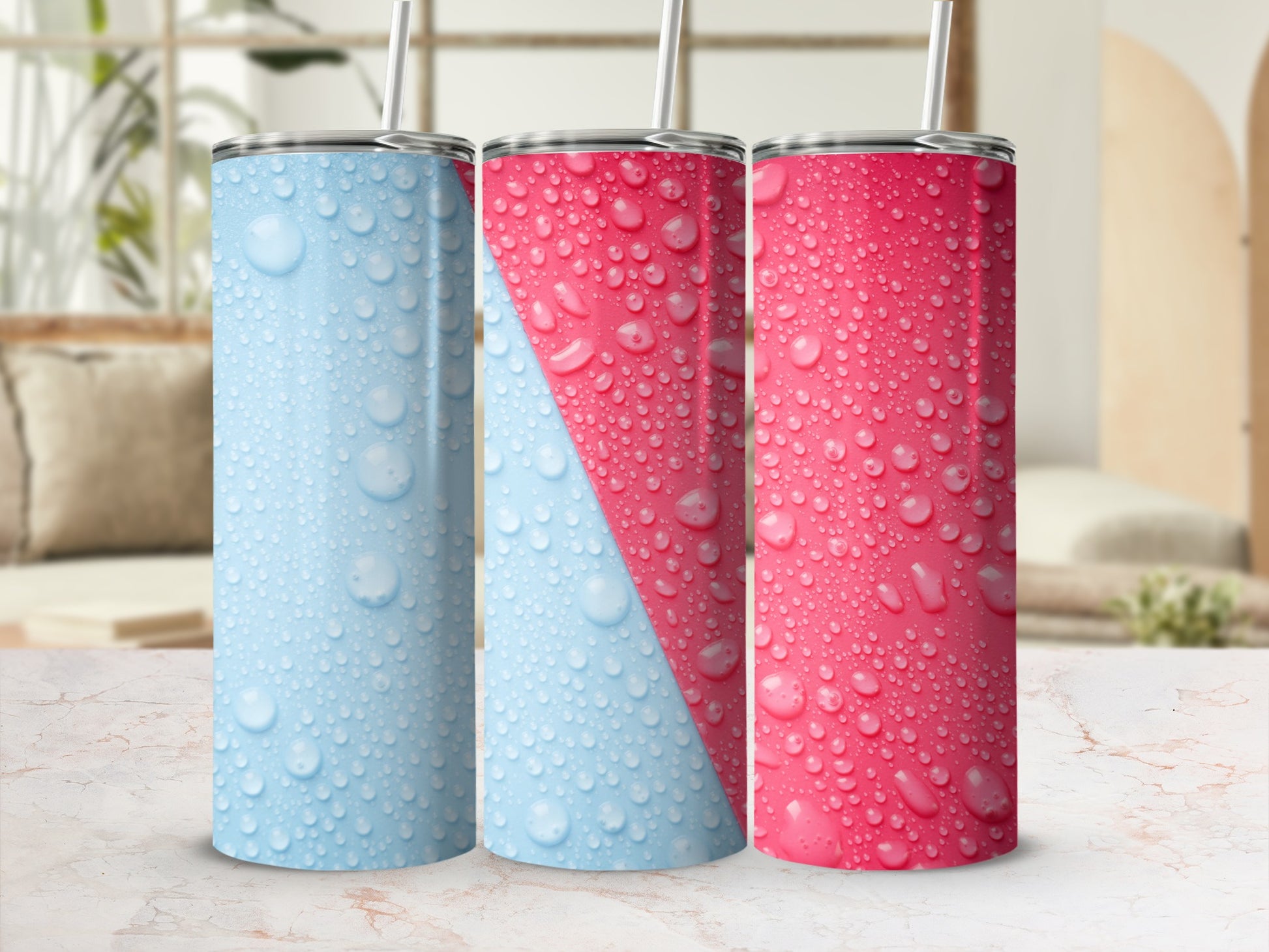 Three stainless steel tumblers with condensation and a pink and blue diagonal stripe design.